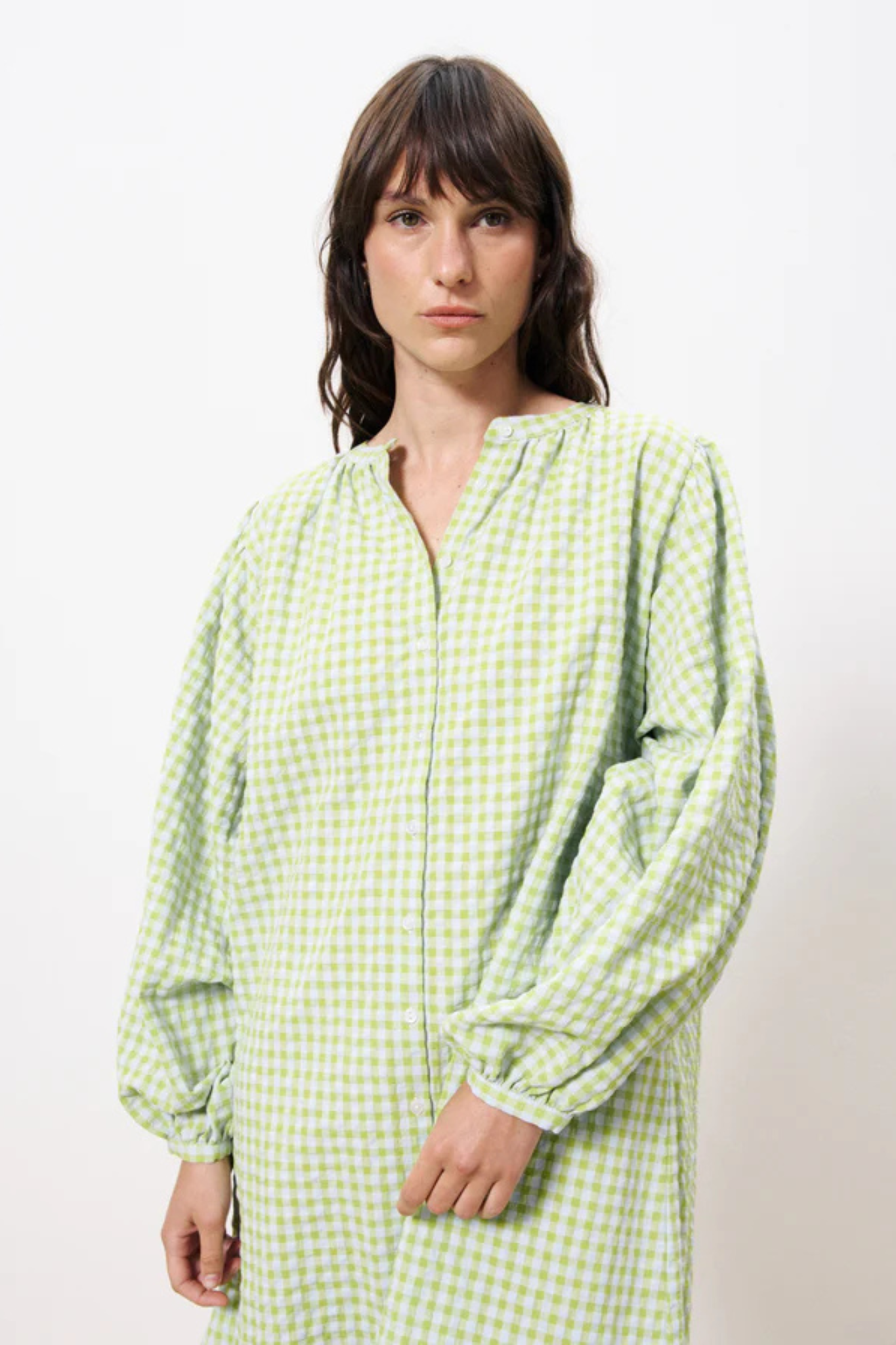 Model wearing the FRNCH noely dress in green checked. Close front view