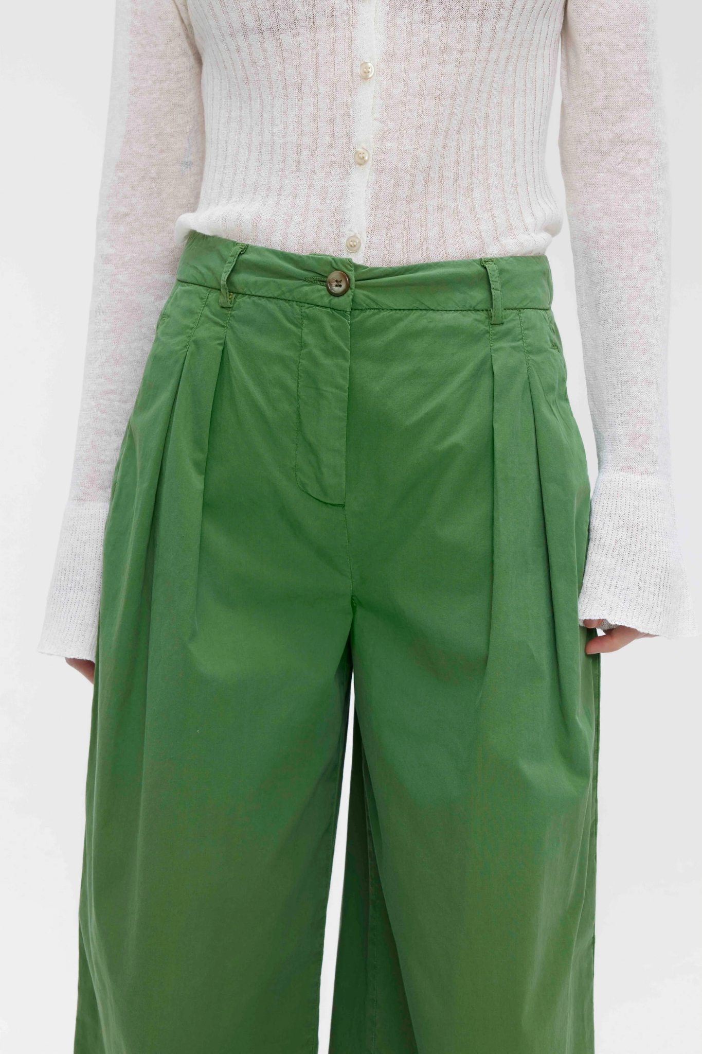 Model wearing the Our Sister Pansmokeyc pants in green. Close front view