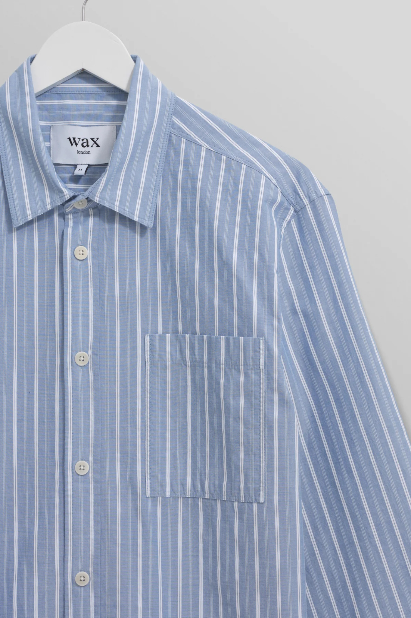 Wax London rove poplin stripe shirt in blue. Front flatlay view 