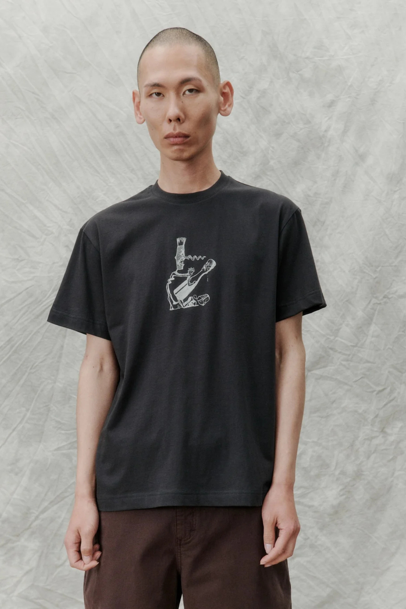 Model wearing the Libertine Libertine beat corkscrew t-shirt in charcoal. Front view