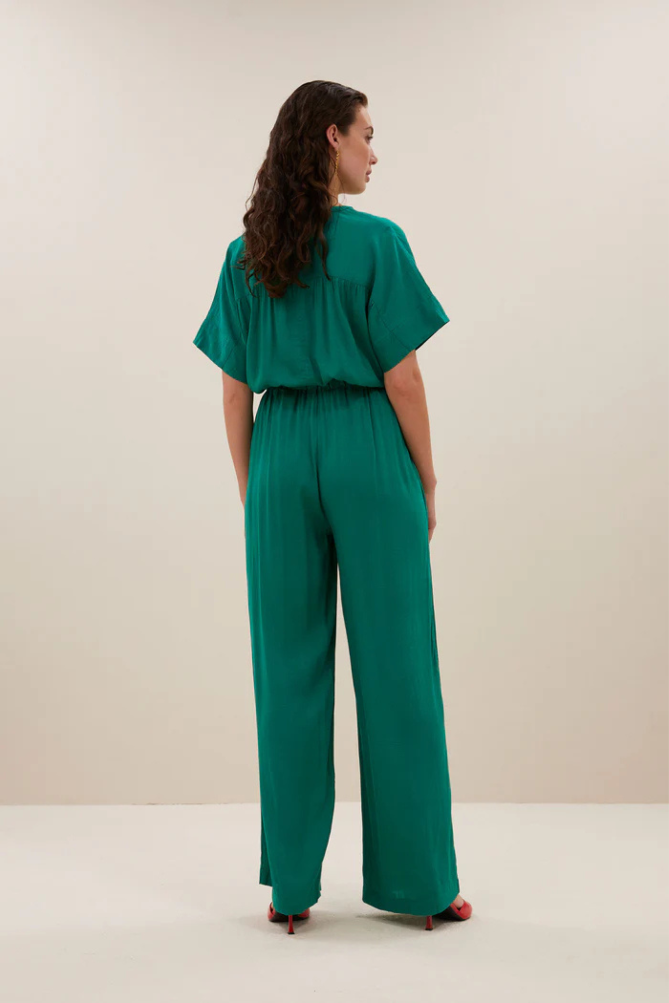 Model wearing the By-Bar bo dobby blouse in bright green. Back view