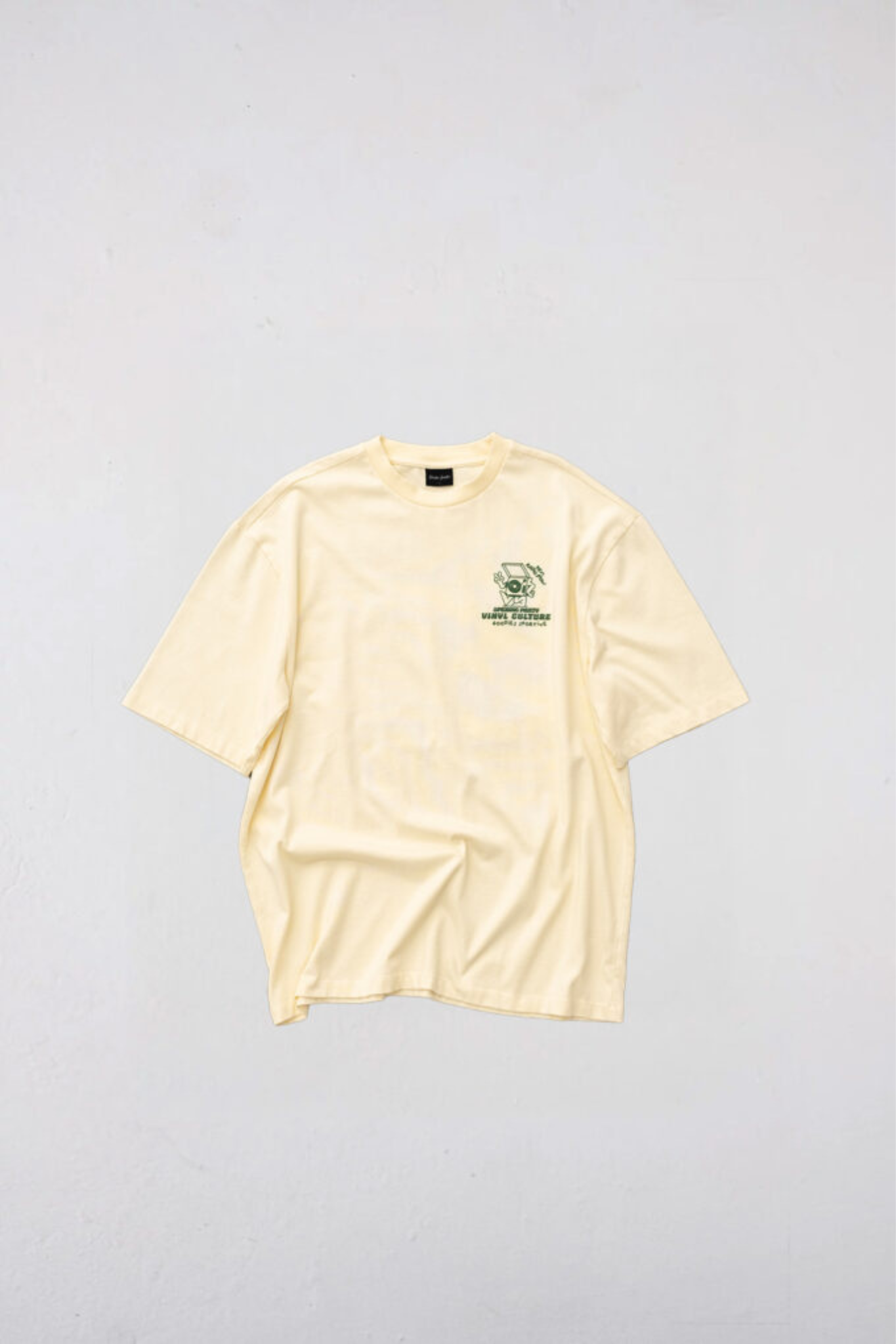 Goodies Sportive vinyl culture t-shirt in butter and graphic in green. Front flatlay view