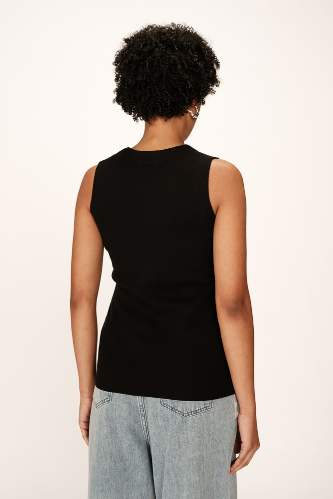 Model wearing the Grace & Mila panama knit cardigan in black. Back view