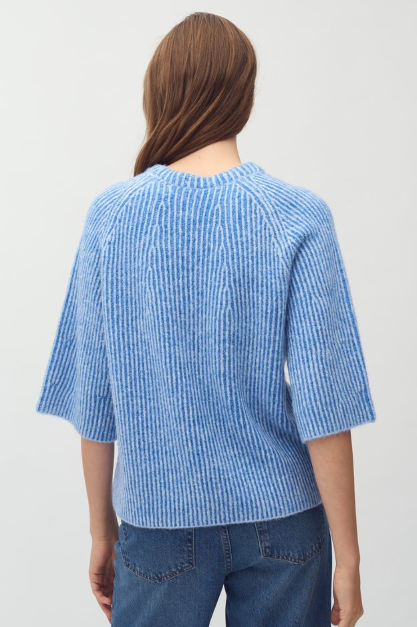 Model wearing the Mbym ubeda hevelyn knit in blue. Back view