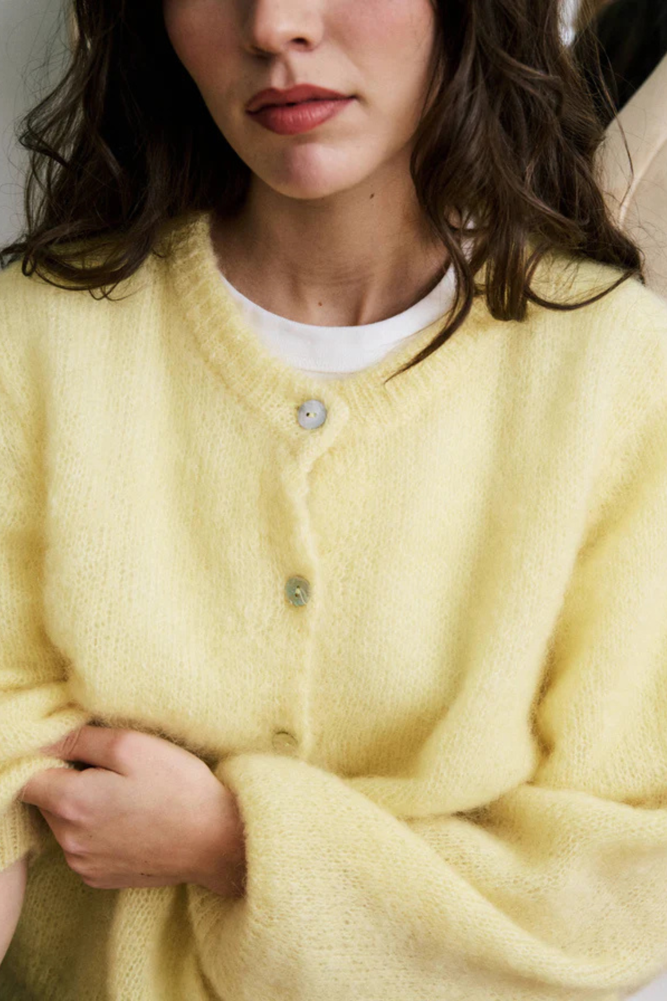 Model wearing the FRNCH calixta cardigan in butter/yellow. Close front view