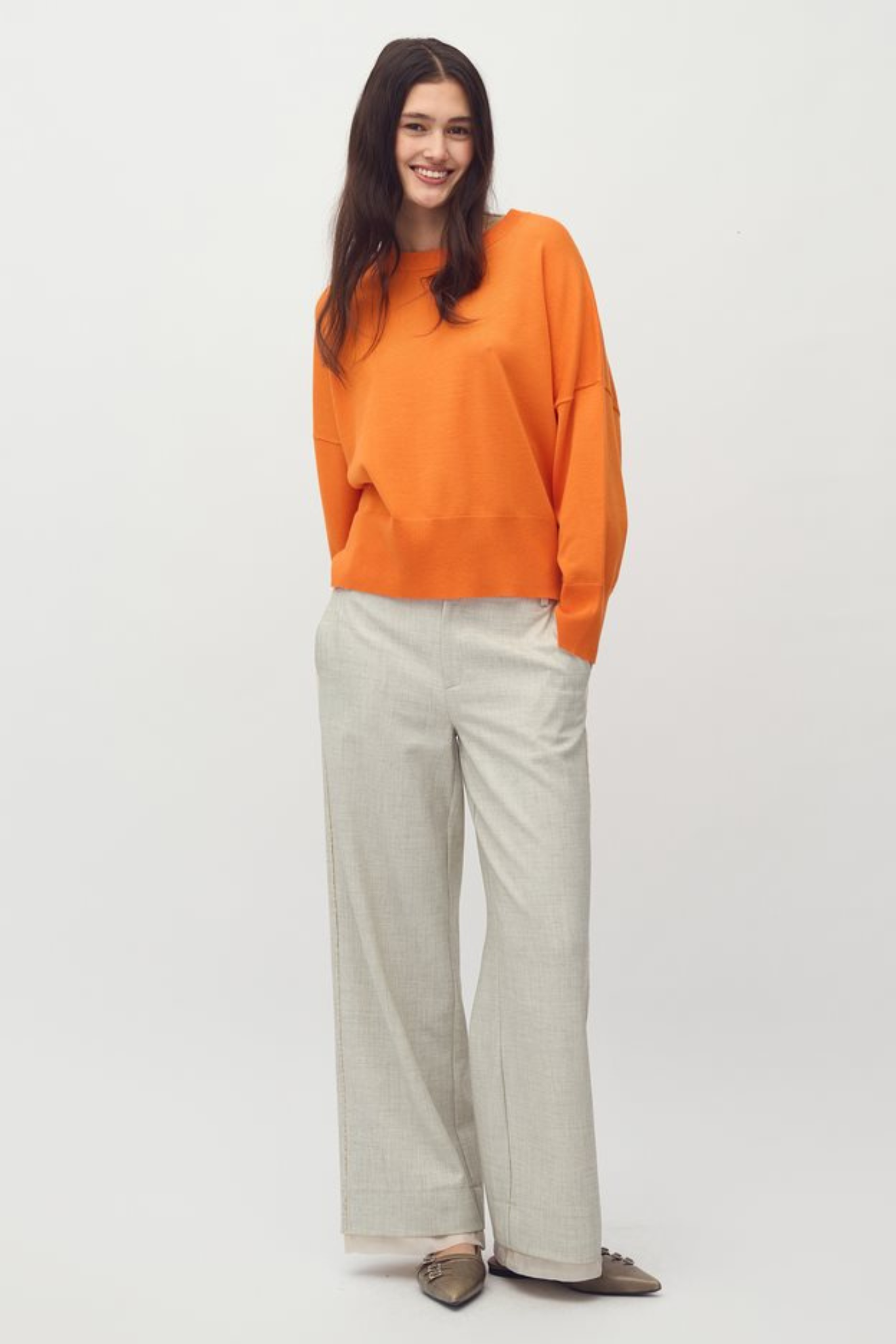 Model wearing the MBYM bravani gillian knit in orange peel. Front view