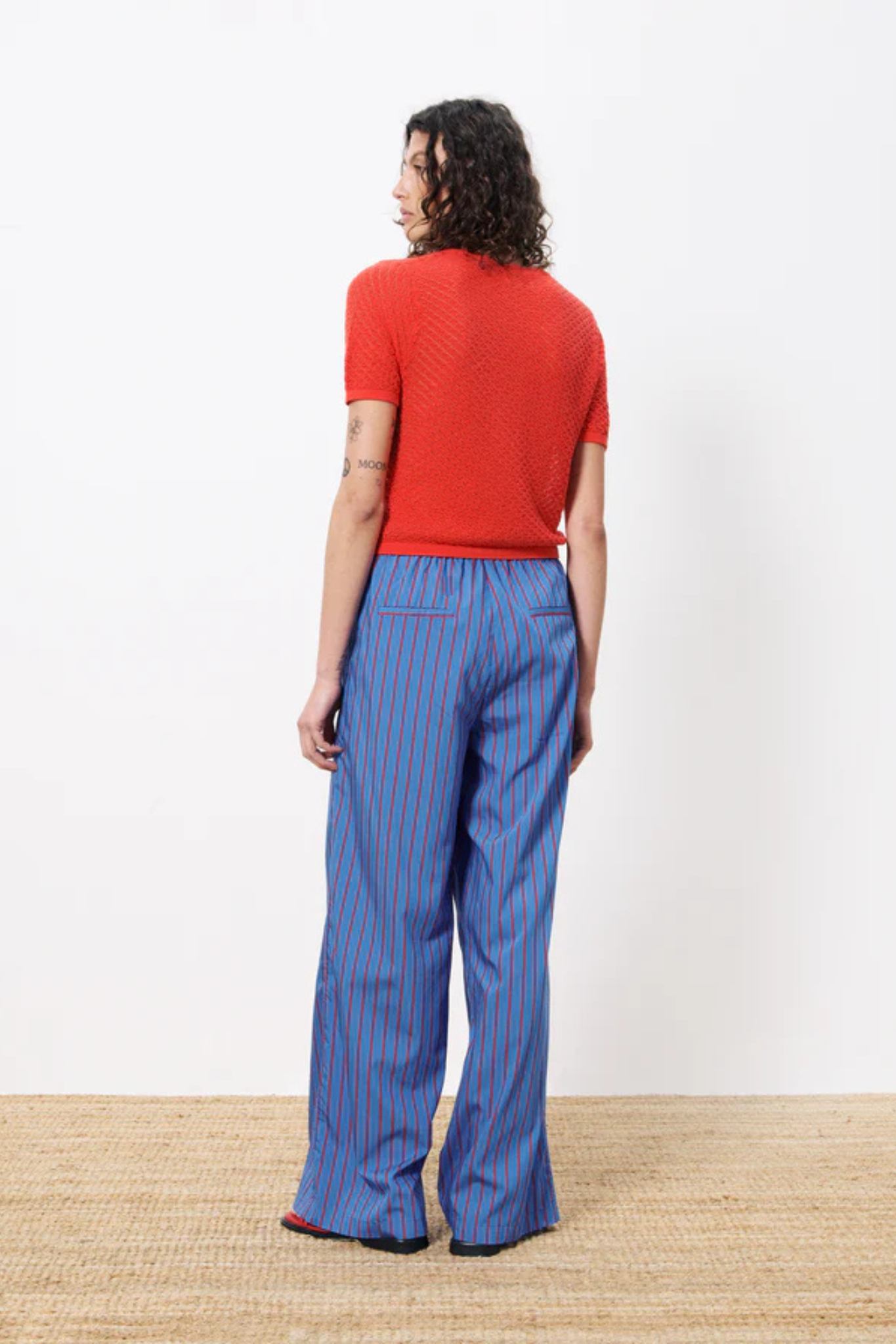 Model wearing the FRNCH edeline pants in blue electrique and red. Back view