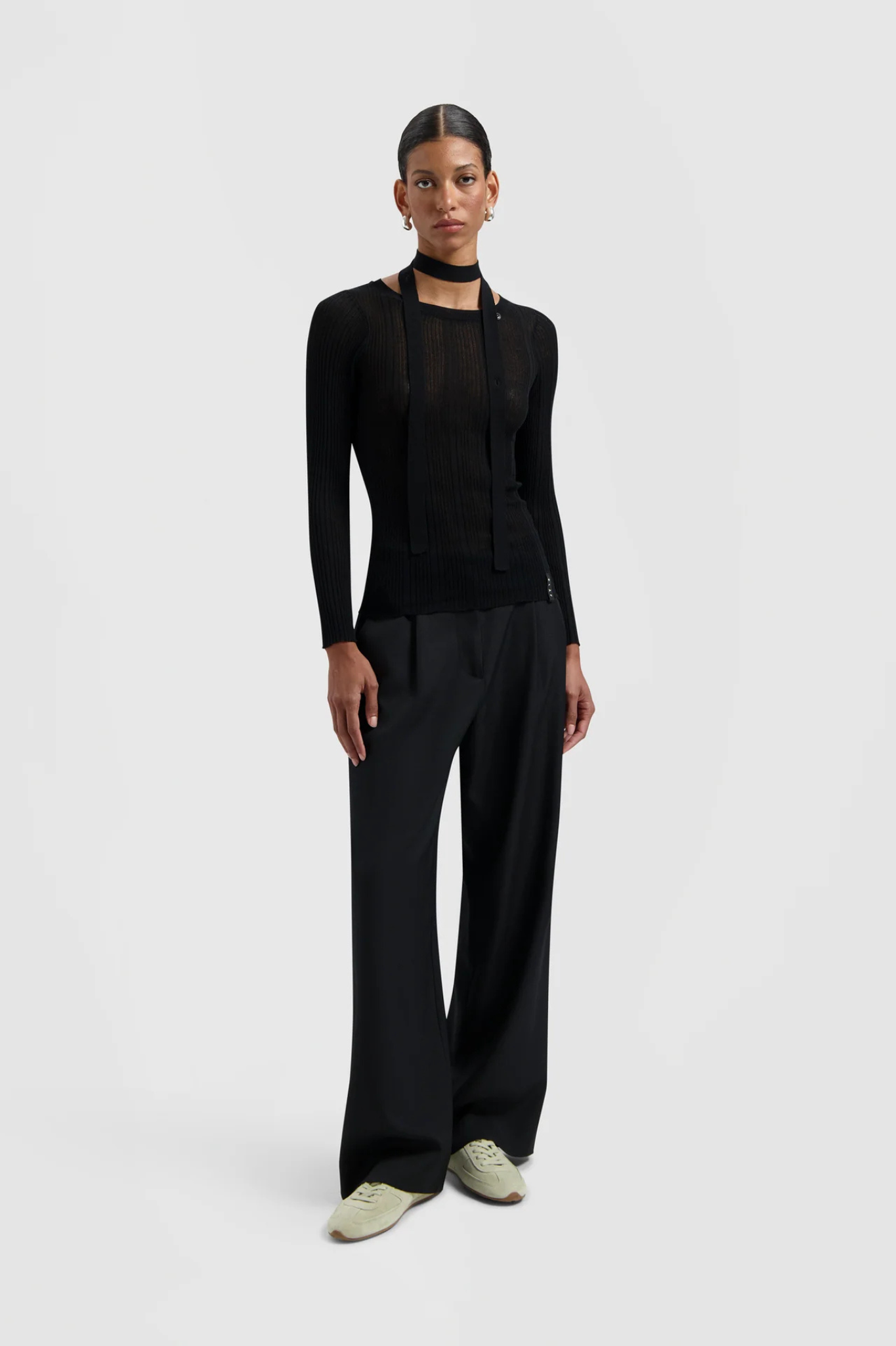 Model wearing the Olaf tailored trousers in black. Front view