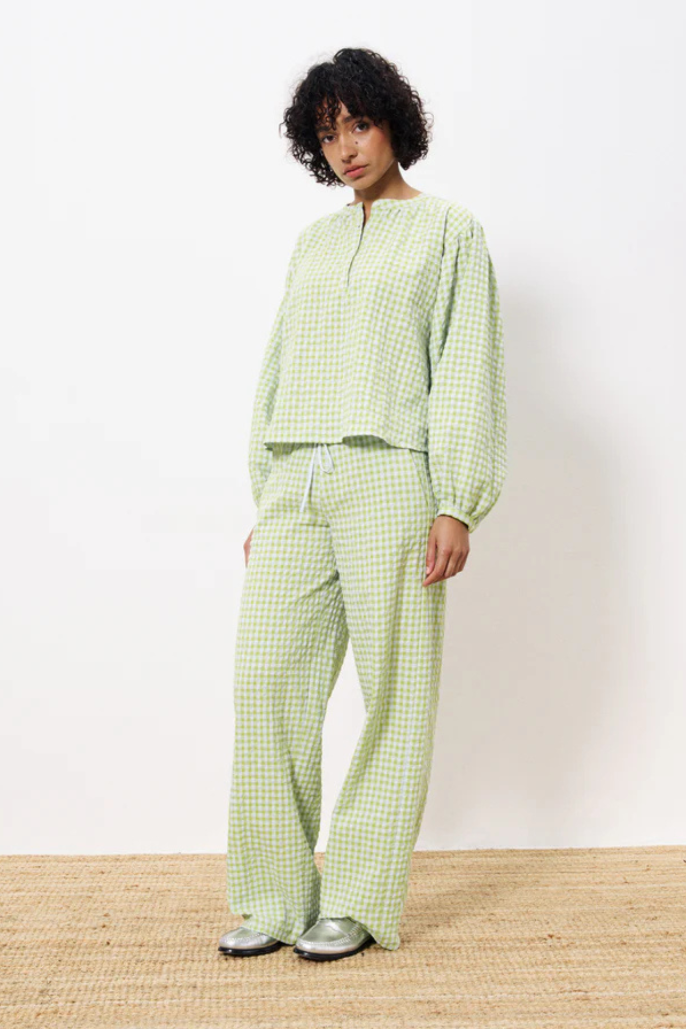 Model wearing the FRNCH ismery pants in green checked. Front view