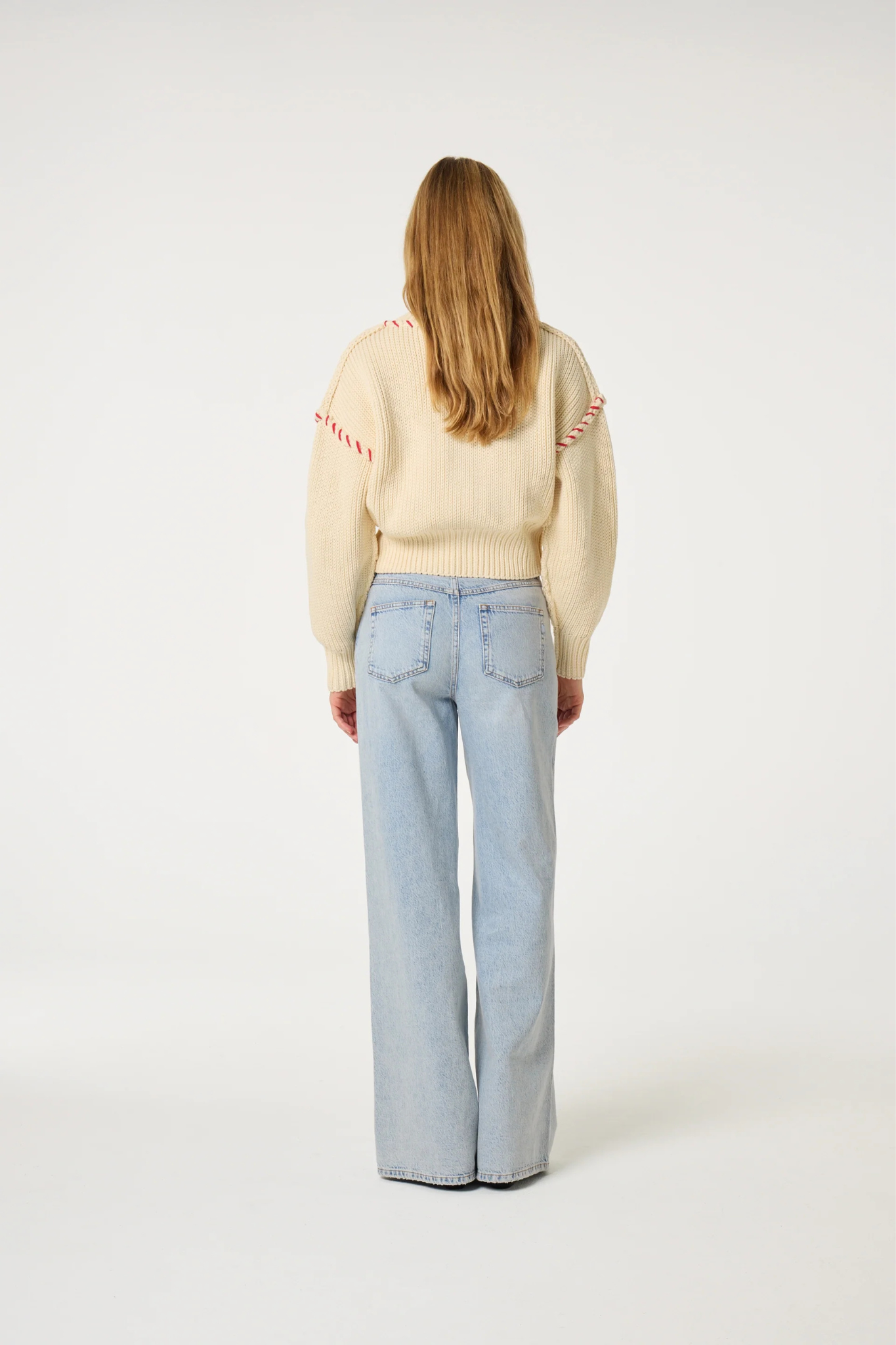 Model wearing the Fabienne Chapot alex wide leg jeans in faded light blue. Back view