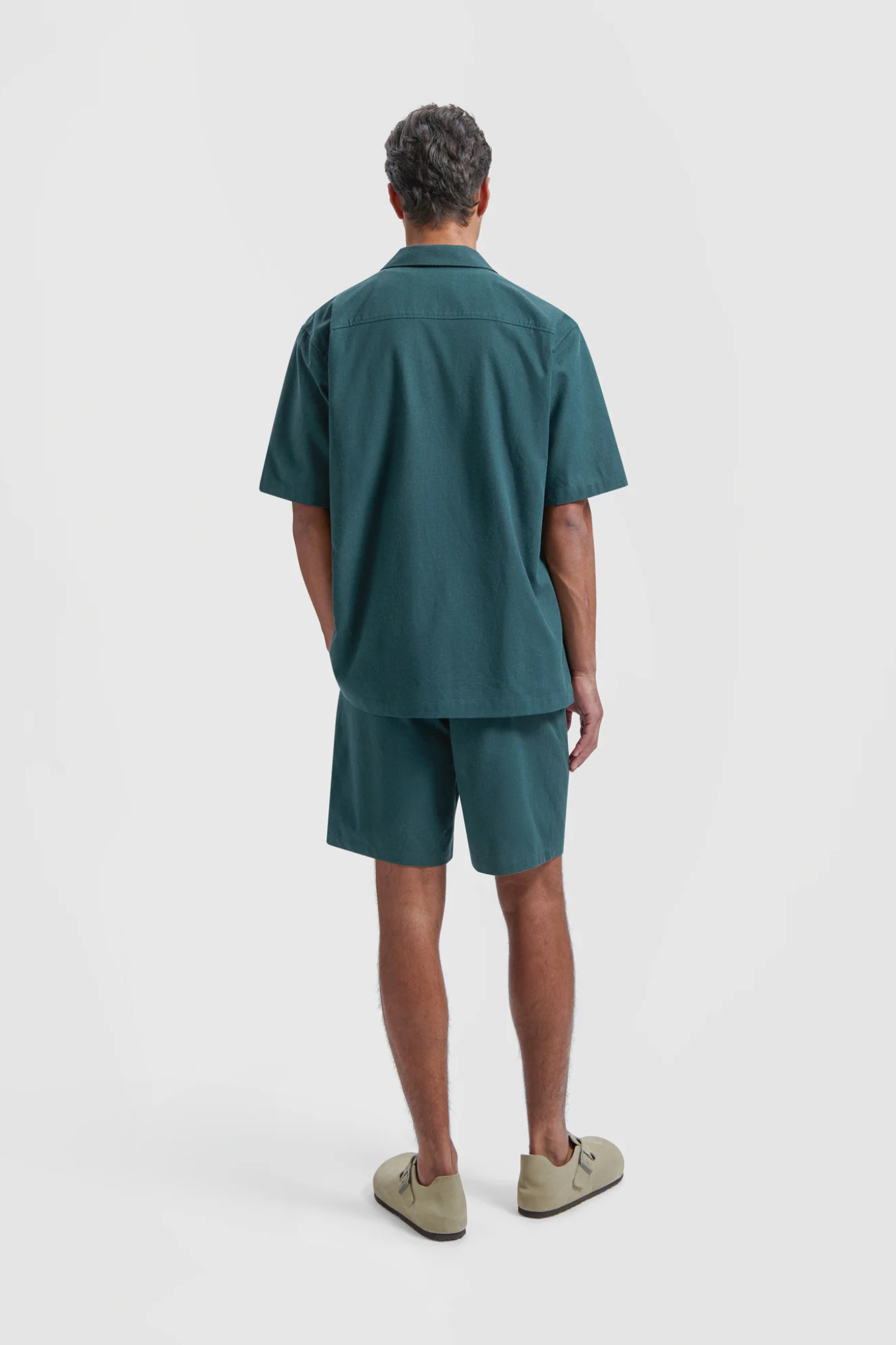 Model wearing the Olaf linen camp shirt in green. Back view