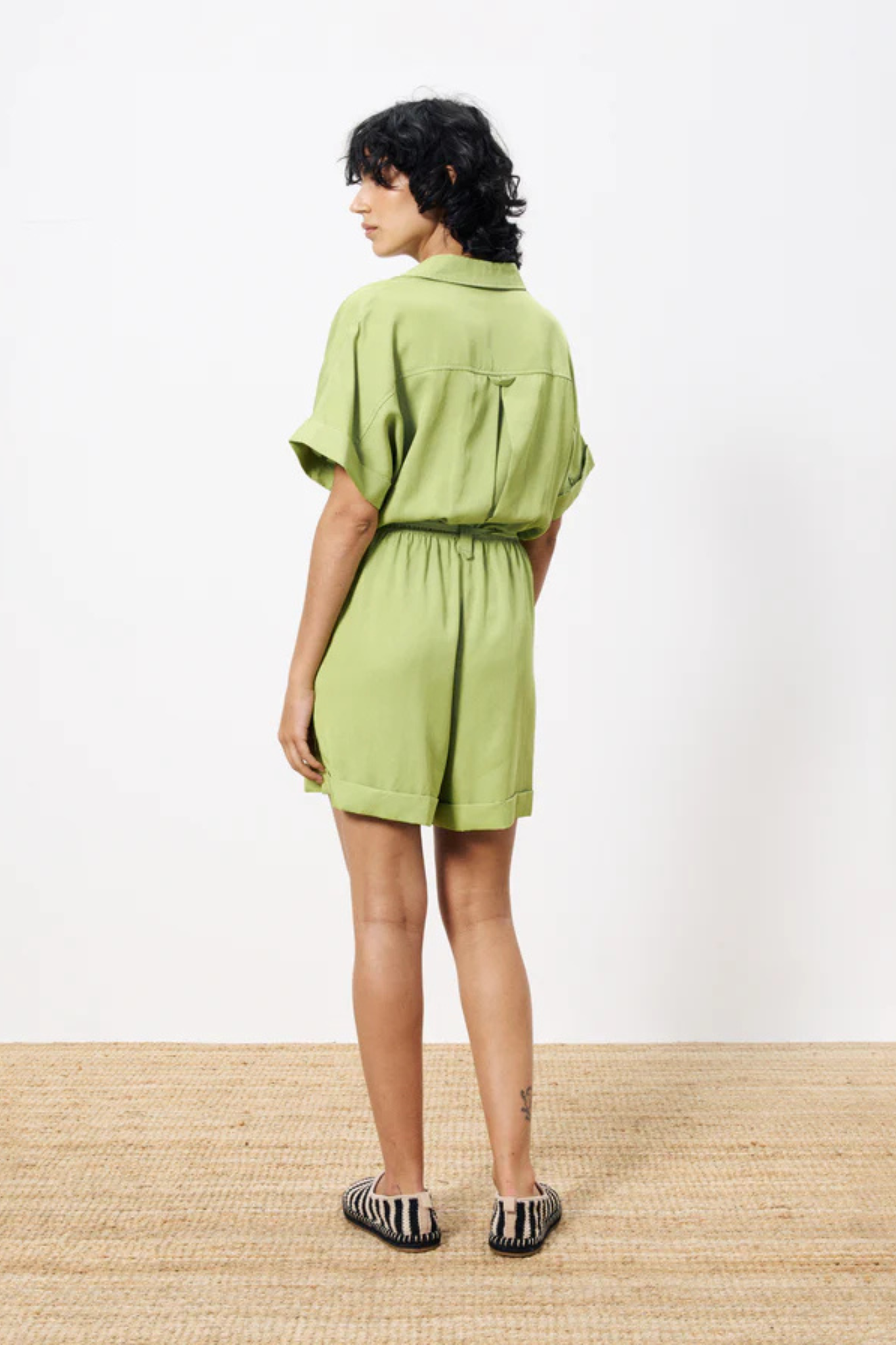 Model wearing the FRNCH lily combishort in green. Back view