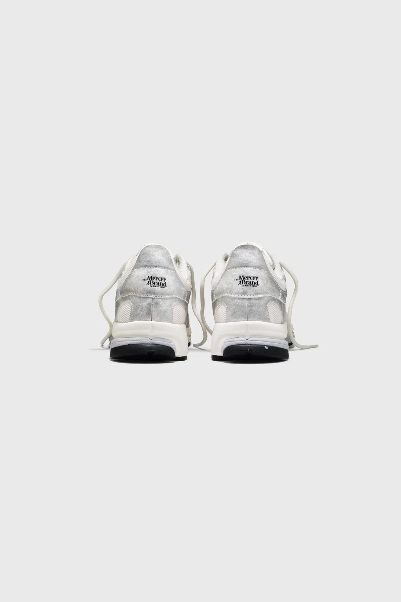 Mercer re-run metallic sneakers in silver. Back view