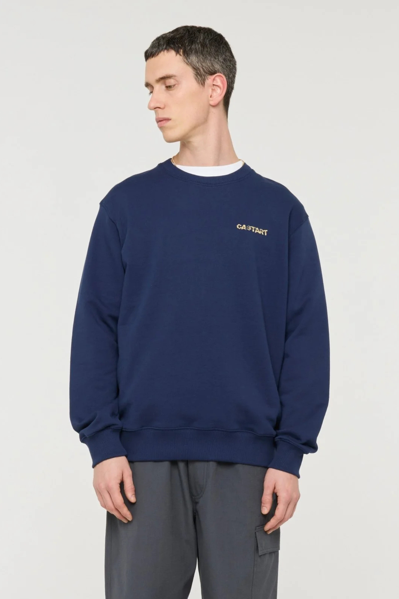 Model wearing the Castart sumo sweatshirt in navy. Front view