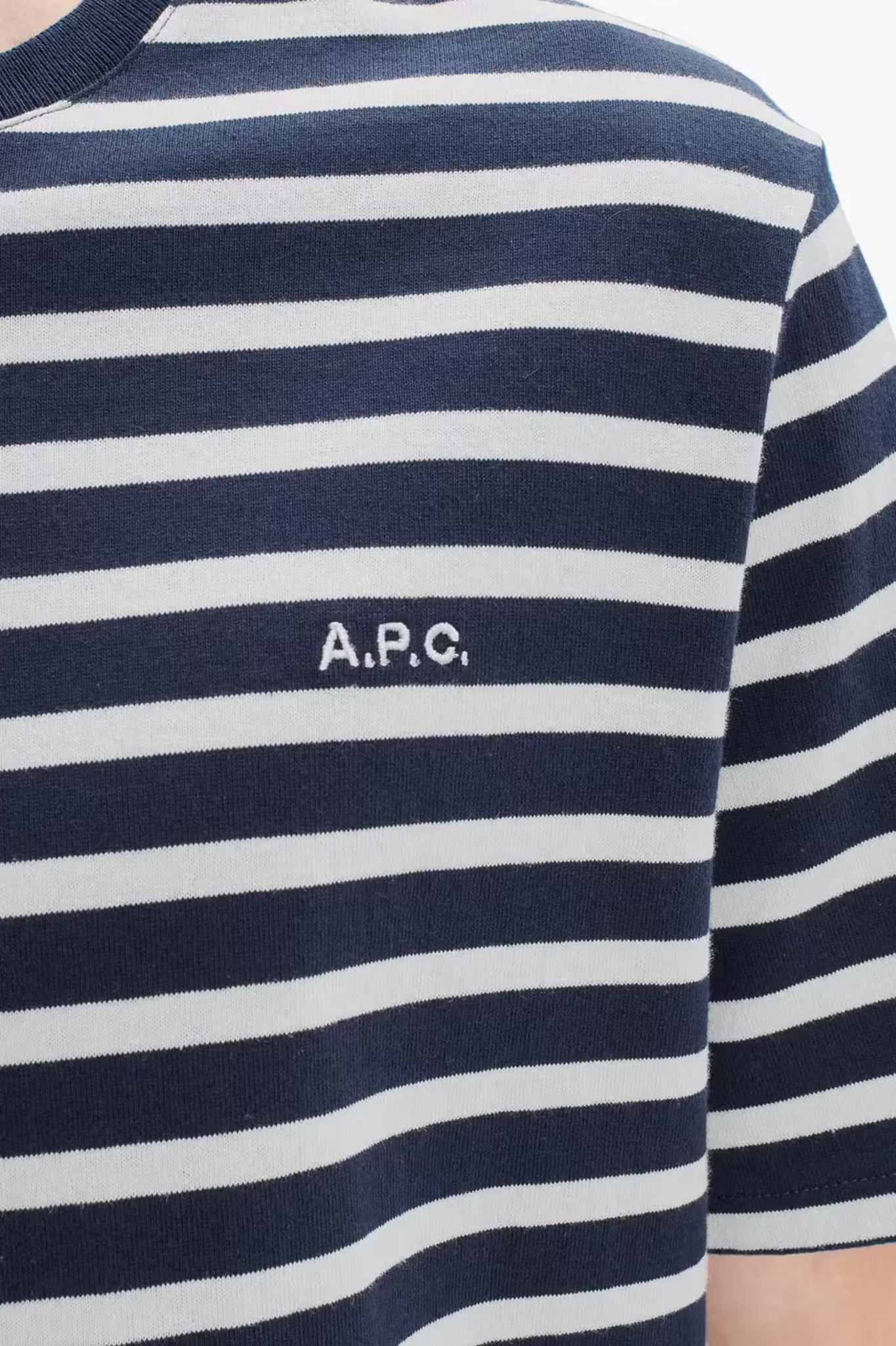 Model wearing the blue and white striped APC t-shirt. Front logo view