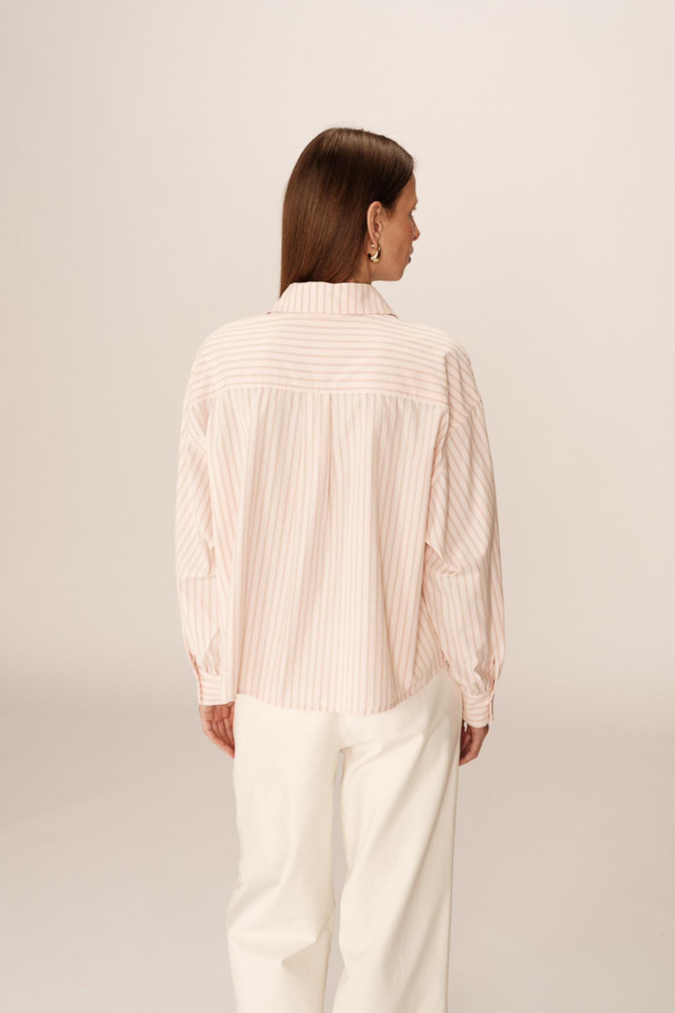 Model wearing the Grace & Mila phoebe shirt in rose. Back view