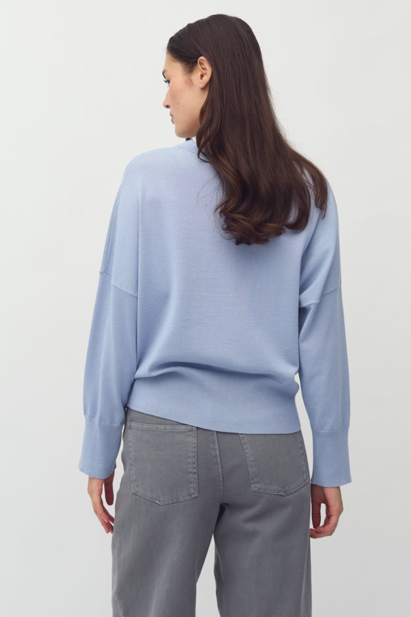 Model wearing the MBYM bravani gillian knit in steel blue. Back view