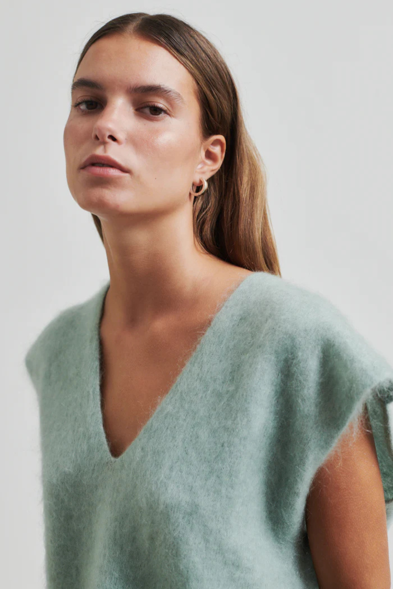 Model wearing the Second Female camryn knit vest in green. Close front view