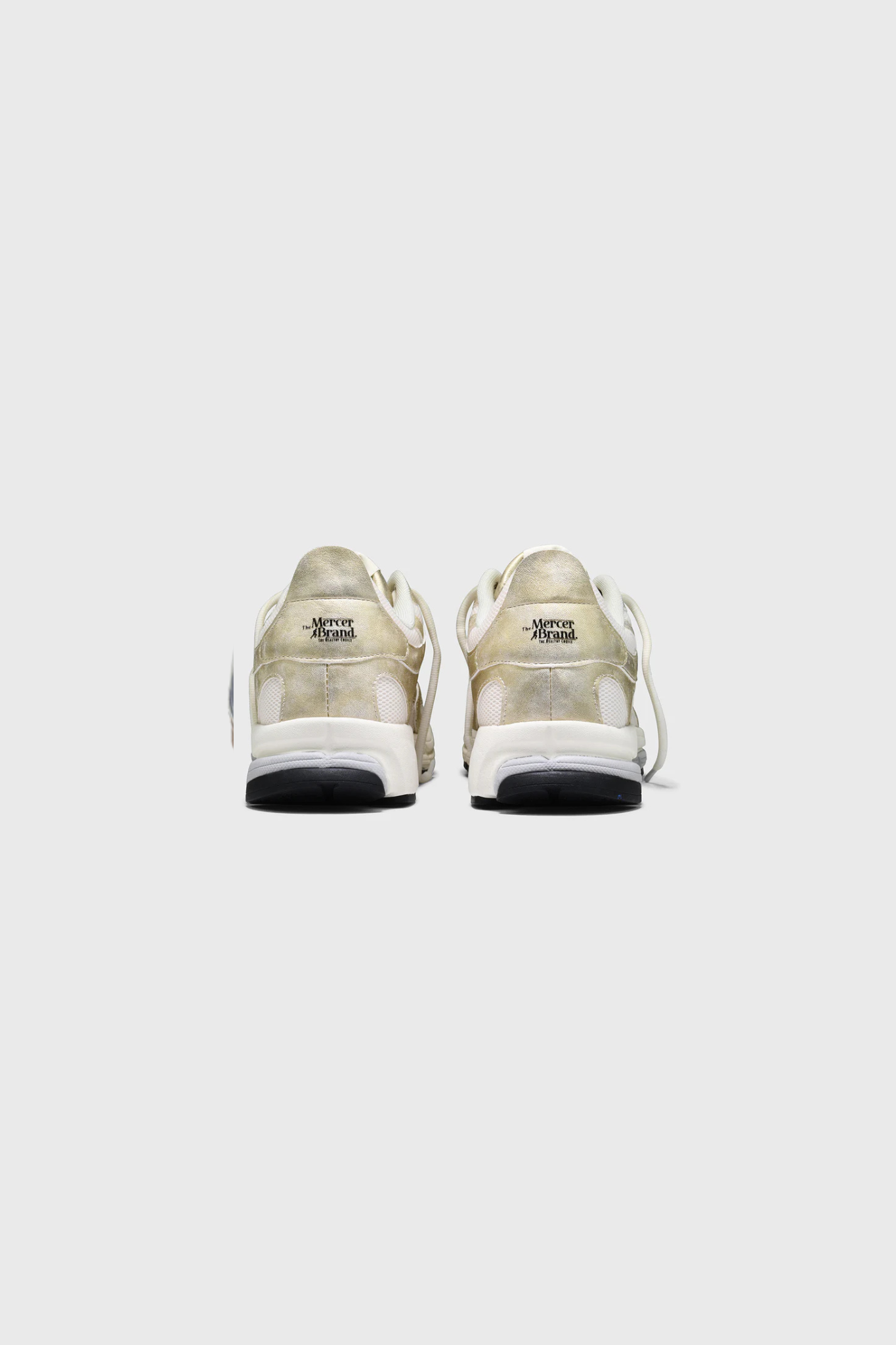 Mercer re-run metallic sneakers in gold. Back view