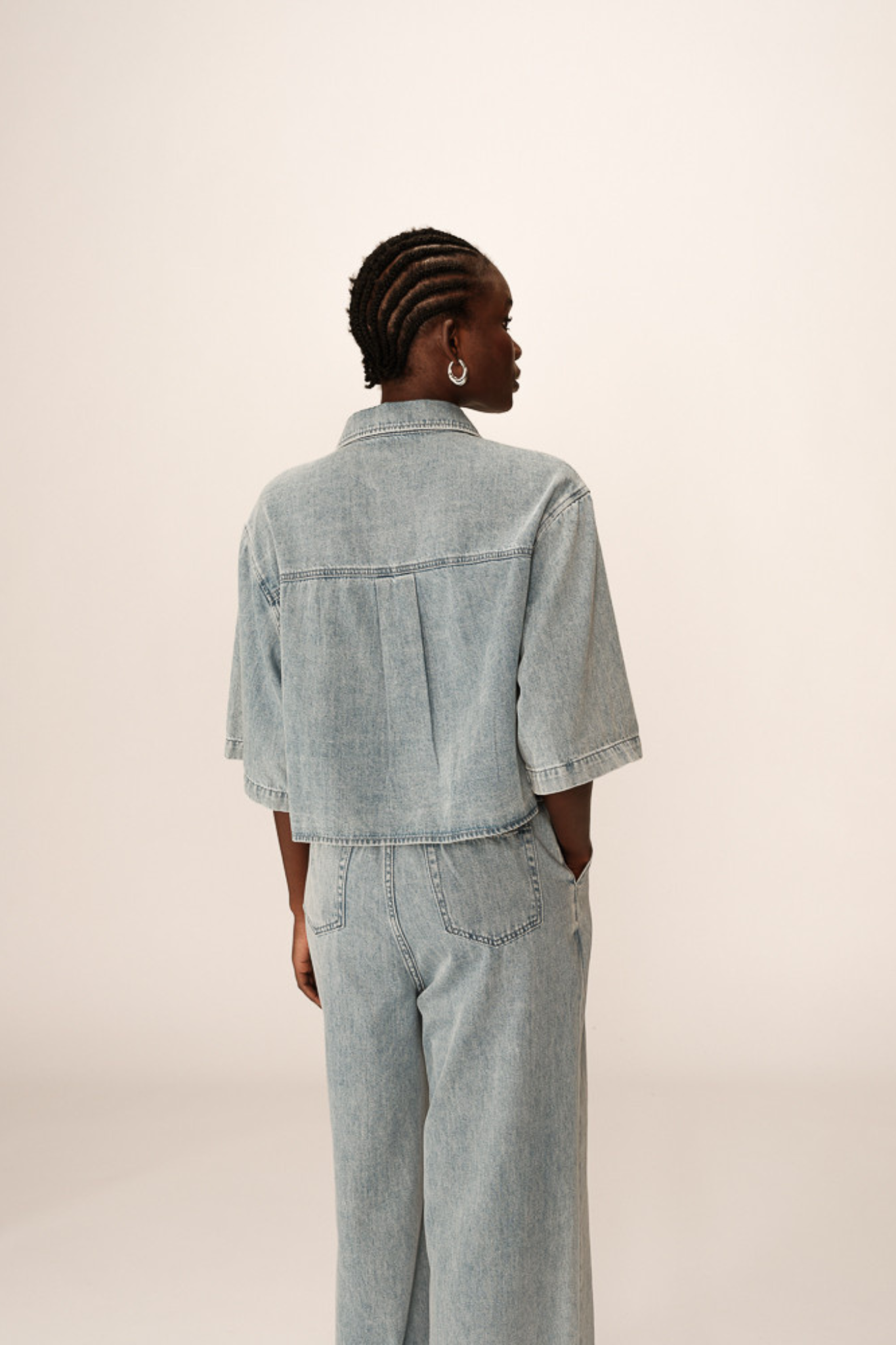 Model wearing the Grace & Mila pomona shirt in denim blue. Back view