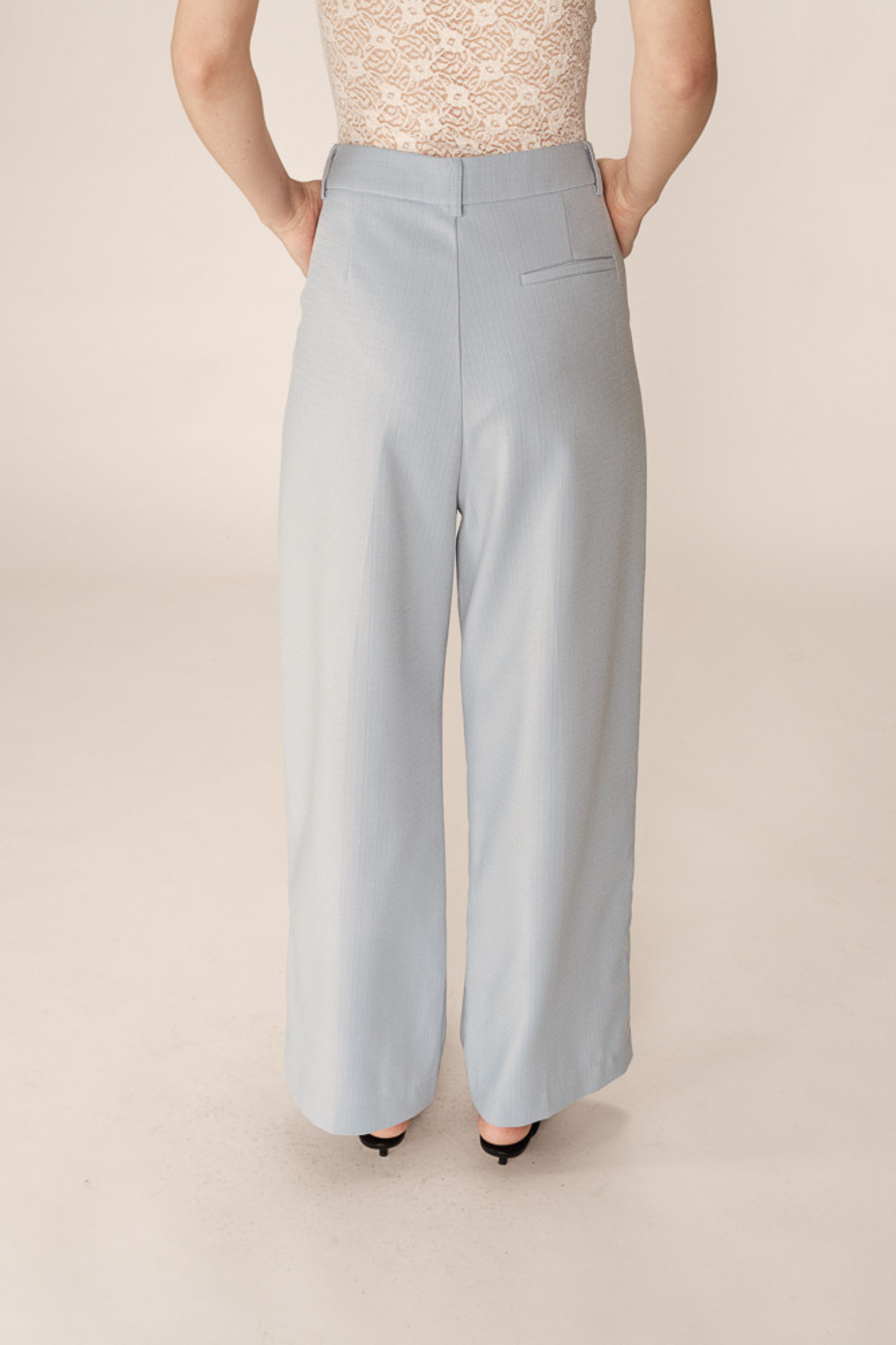 Model wearing the Grace & Mila pierre pants in light blue. Back view