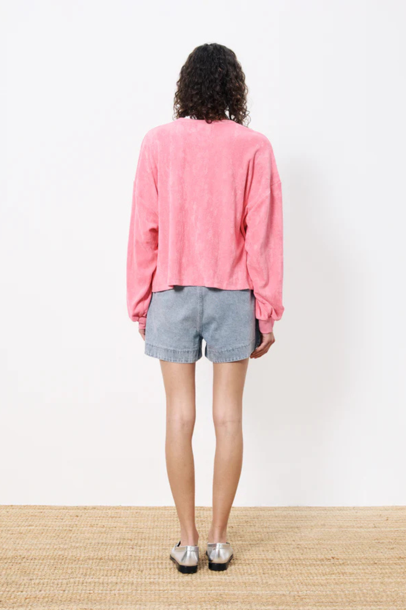 Model wearing the FRNCH calliste sweatshirt in pink. Back view