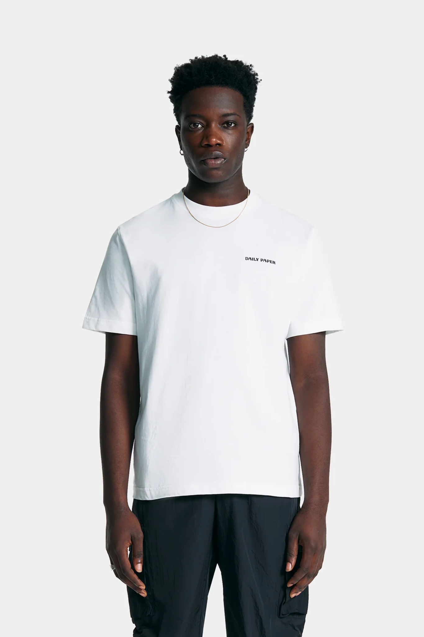 Model wearing the Daily Paper white tshirt with logo in black. Front view