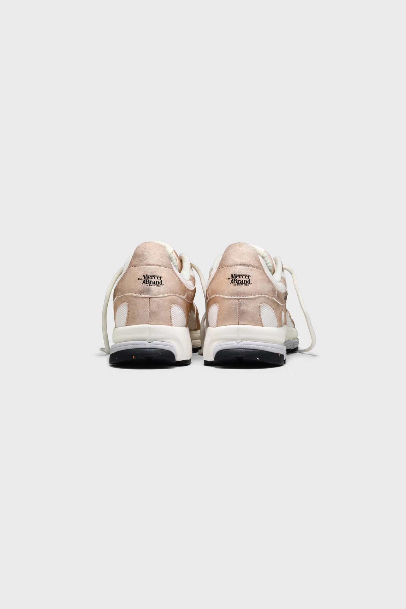 Mercer re-run metallic sneakers in white and pink.  Back view