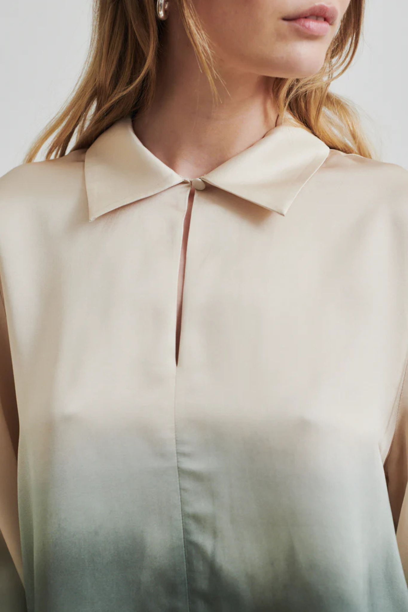 Model wearing the Second Female avora blouse in beige and green. Close front view