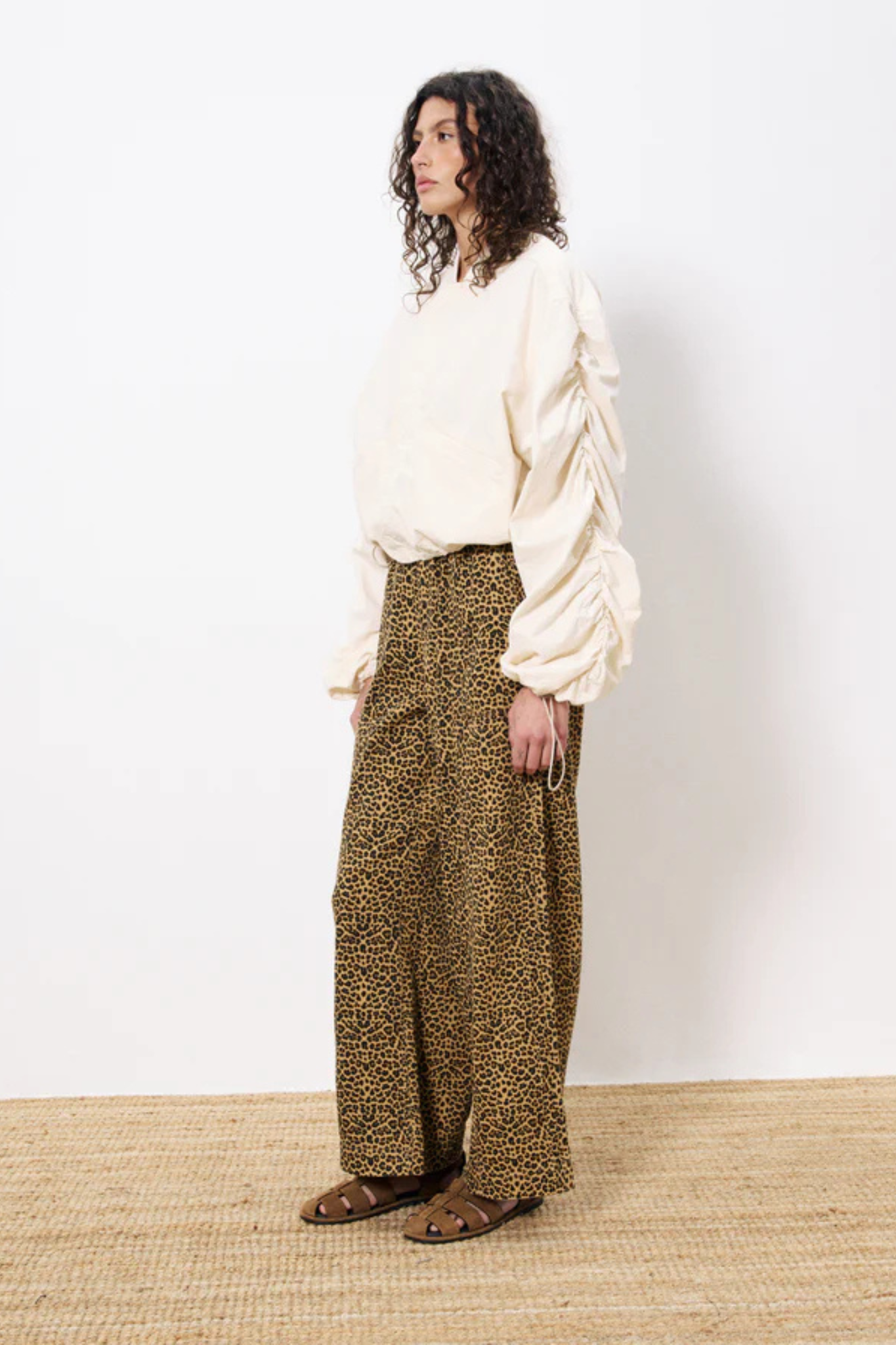 Model wearing the FRNCH cherin pants in leopard. Side view