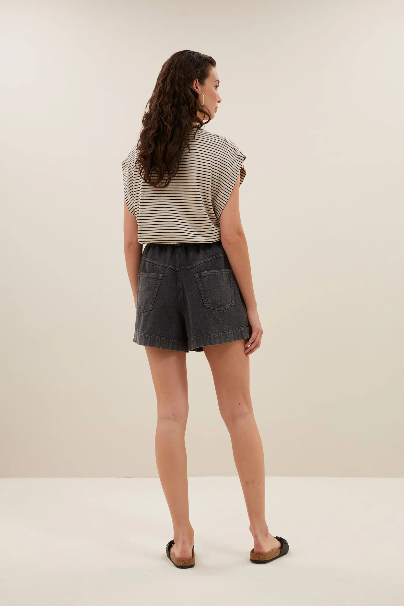 Model wearing the By-Bar mason small stripe top in white and black striped. Back view