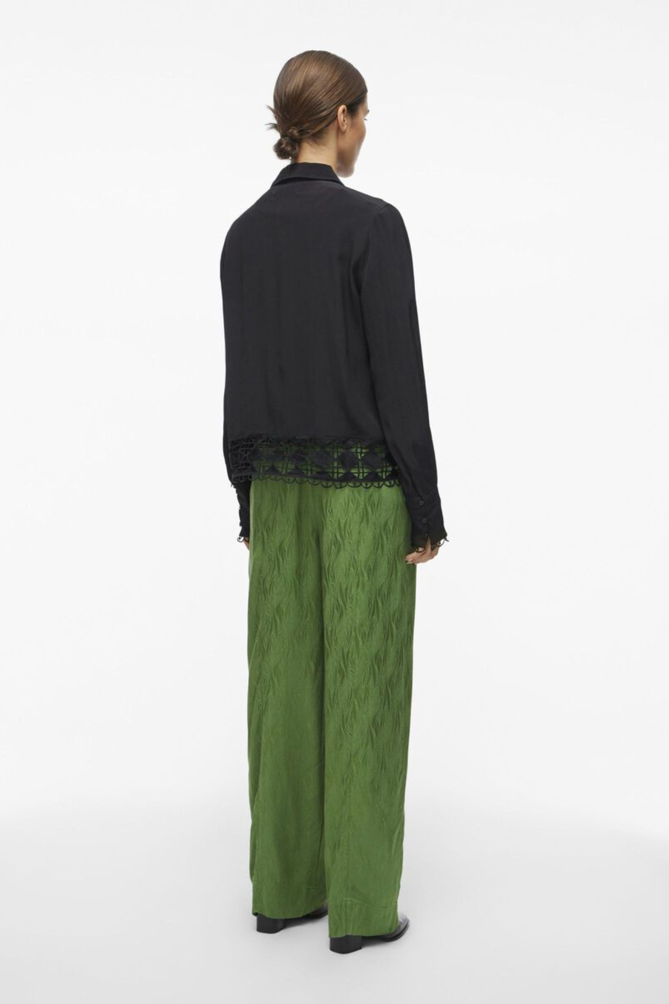 Model wearing the Rouge Edit artichoke green Roumarta trousers. Back view