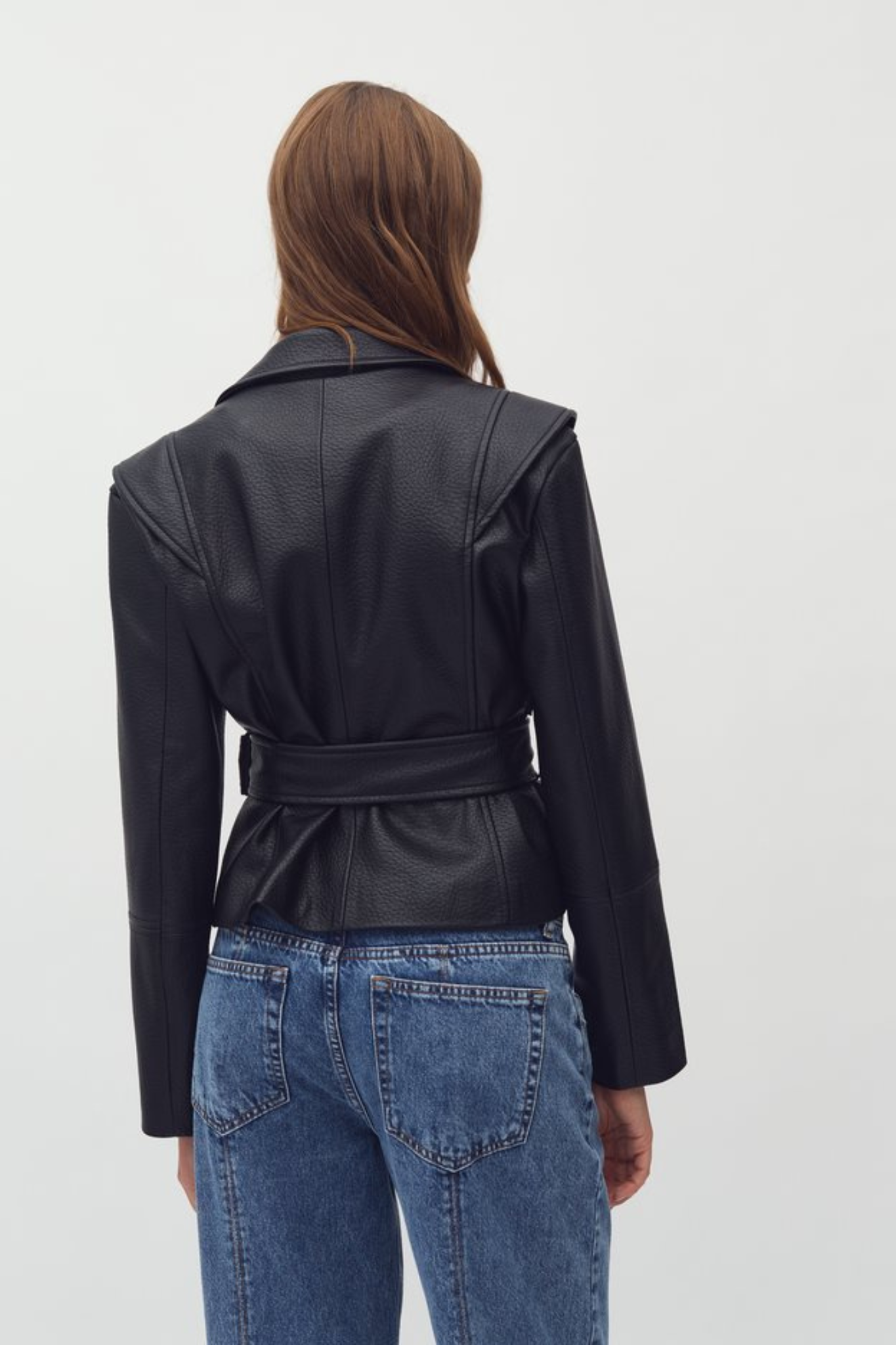 Model wearing the Mbym salivia graina jacket in black. Back view