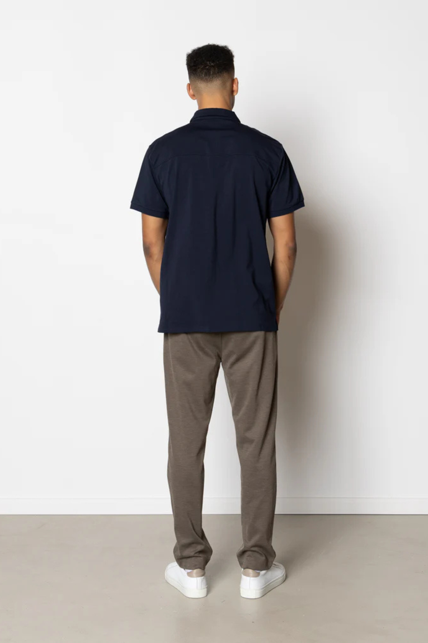 Model wearing the Clean Cut Copenhagen jersey pants in dark khaki. Back view