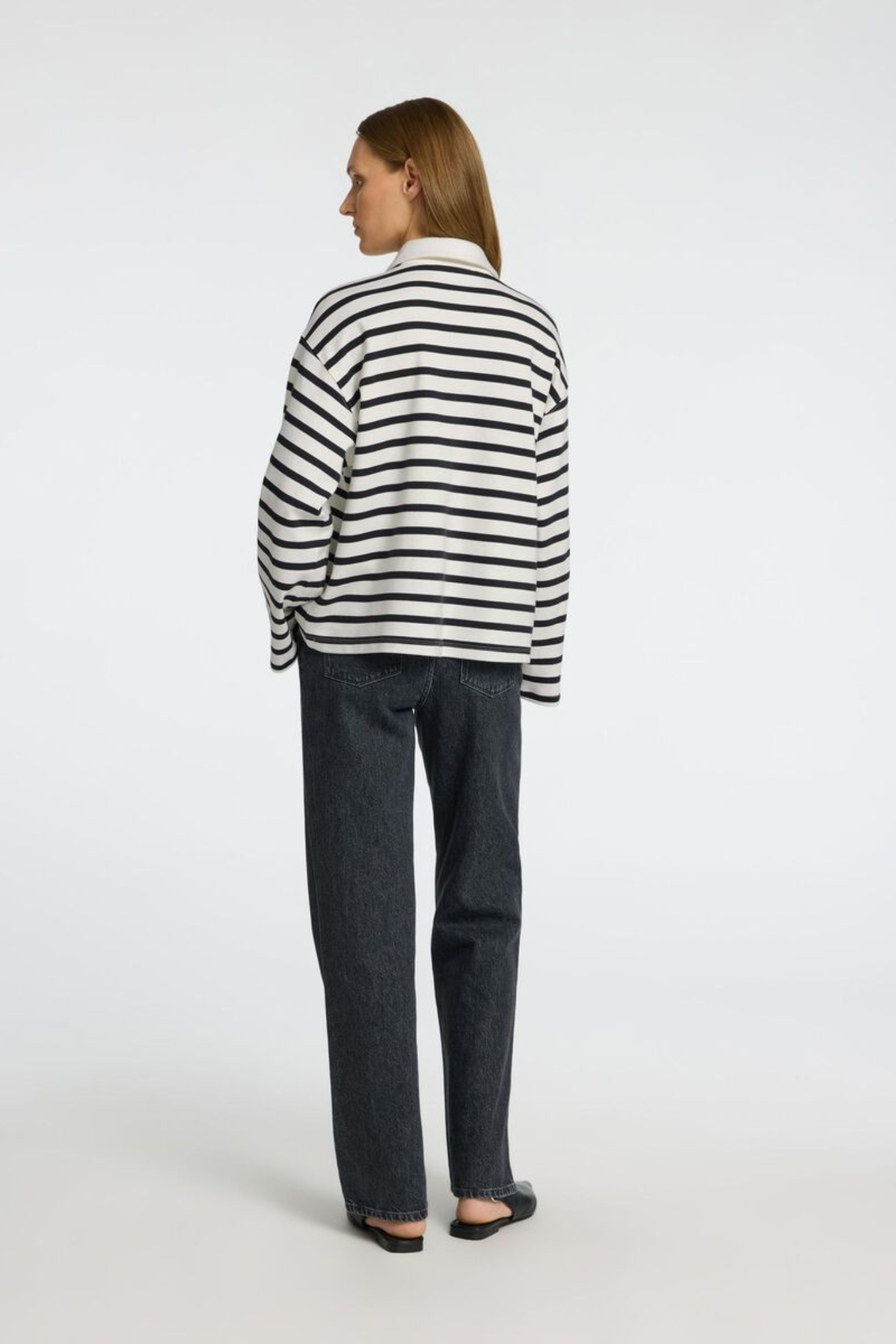 Model wearing the Selected Femme wada stripe collar top in black and white. Back view