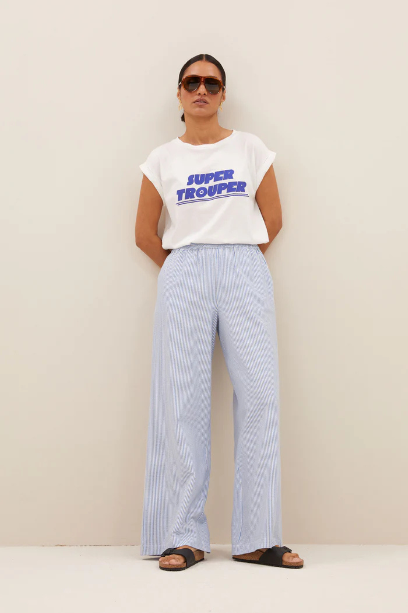 Model wearing the By-Bar randy stripe pants in blue seer stripe. Front view