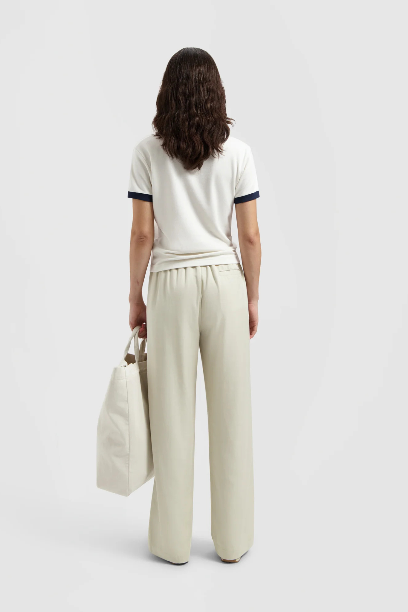 Model wearing the Olaf pintuck elasticated pants in off white. Back view