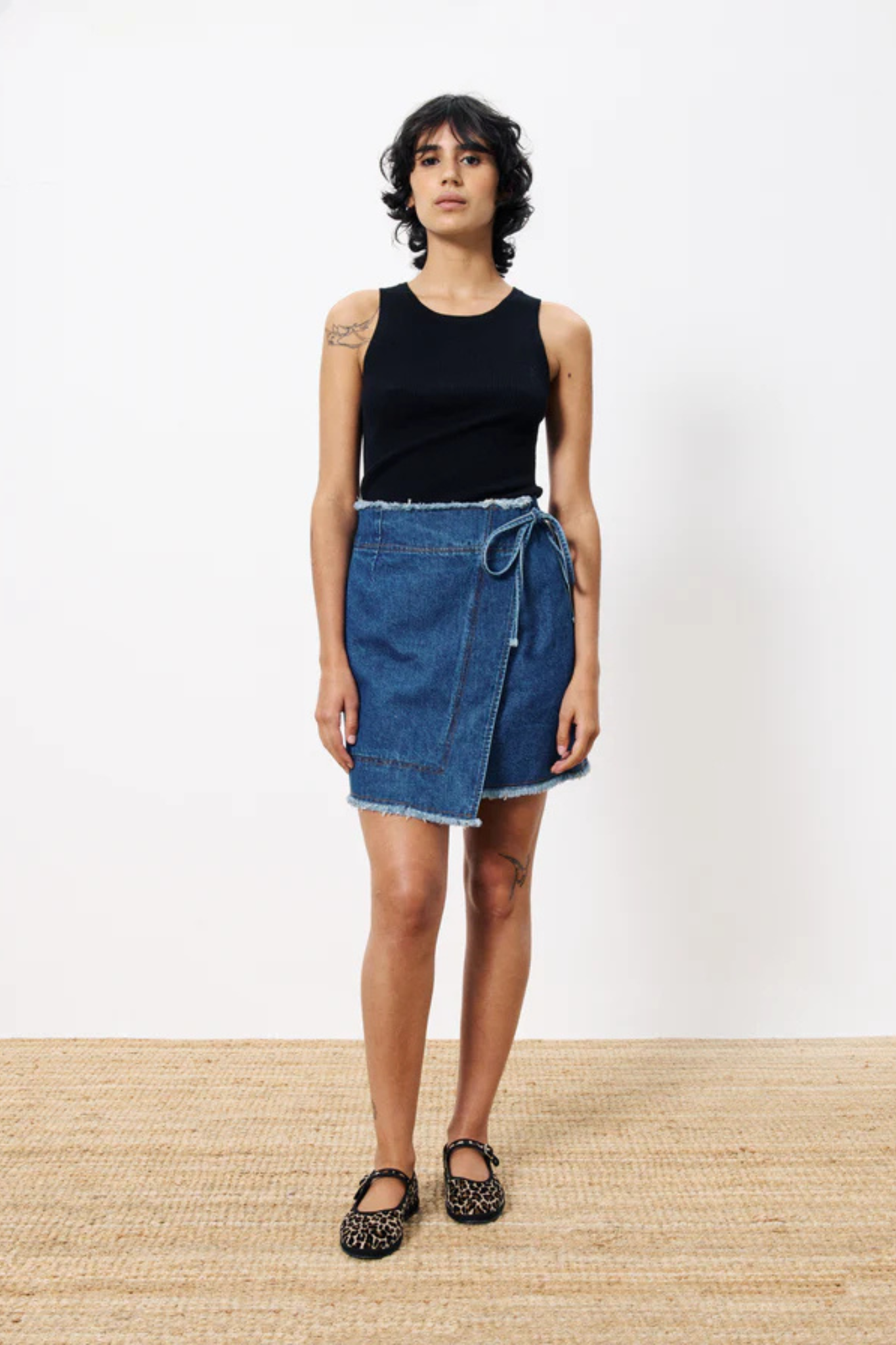 Model wearing the FRNCH nise skirt in blue denim. Front view