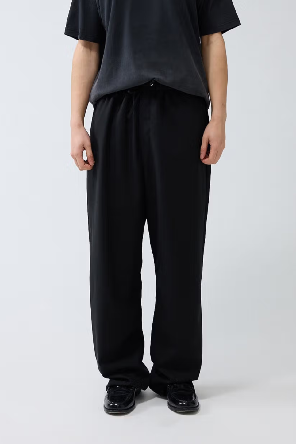 Model wearing the black New Amsterdam wool trousers. Front view