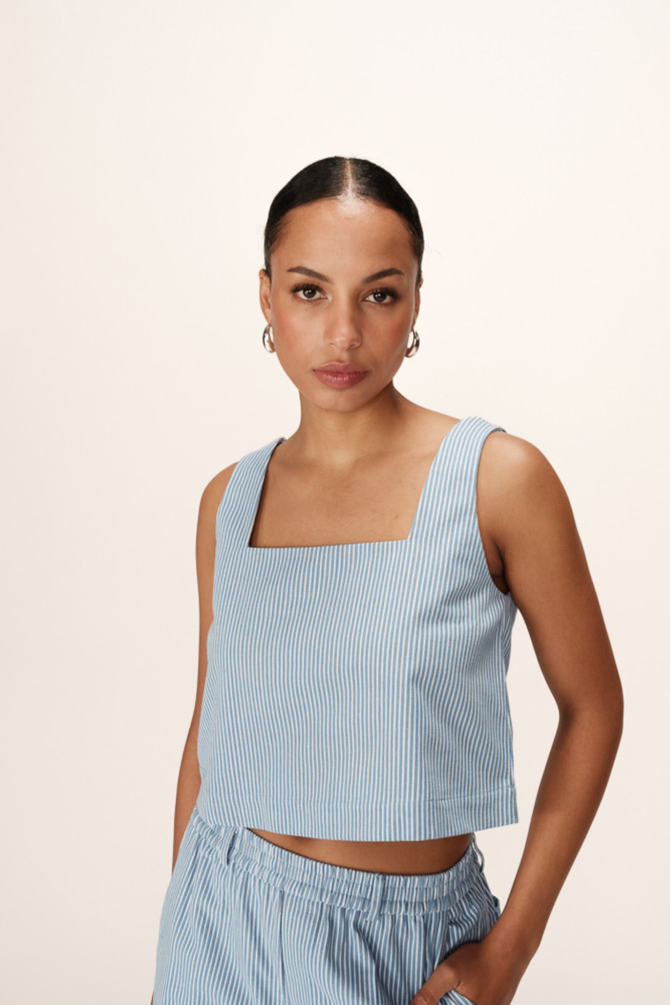 Model wearing the Grace & Mila striped peanut top in white and blue. Front view