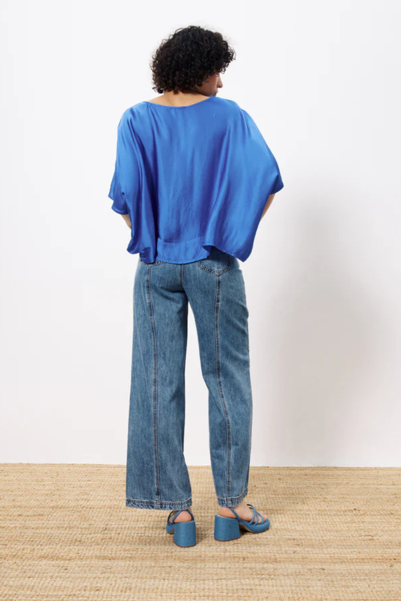 Model wearing the FRNCH sia top in blue. Back view