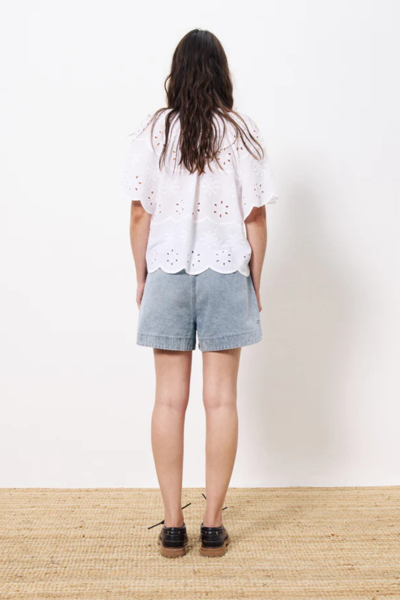 Model wearing the FRNCH neda shirt in white. Back view