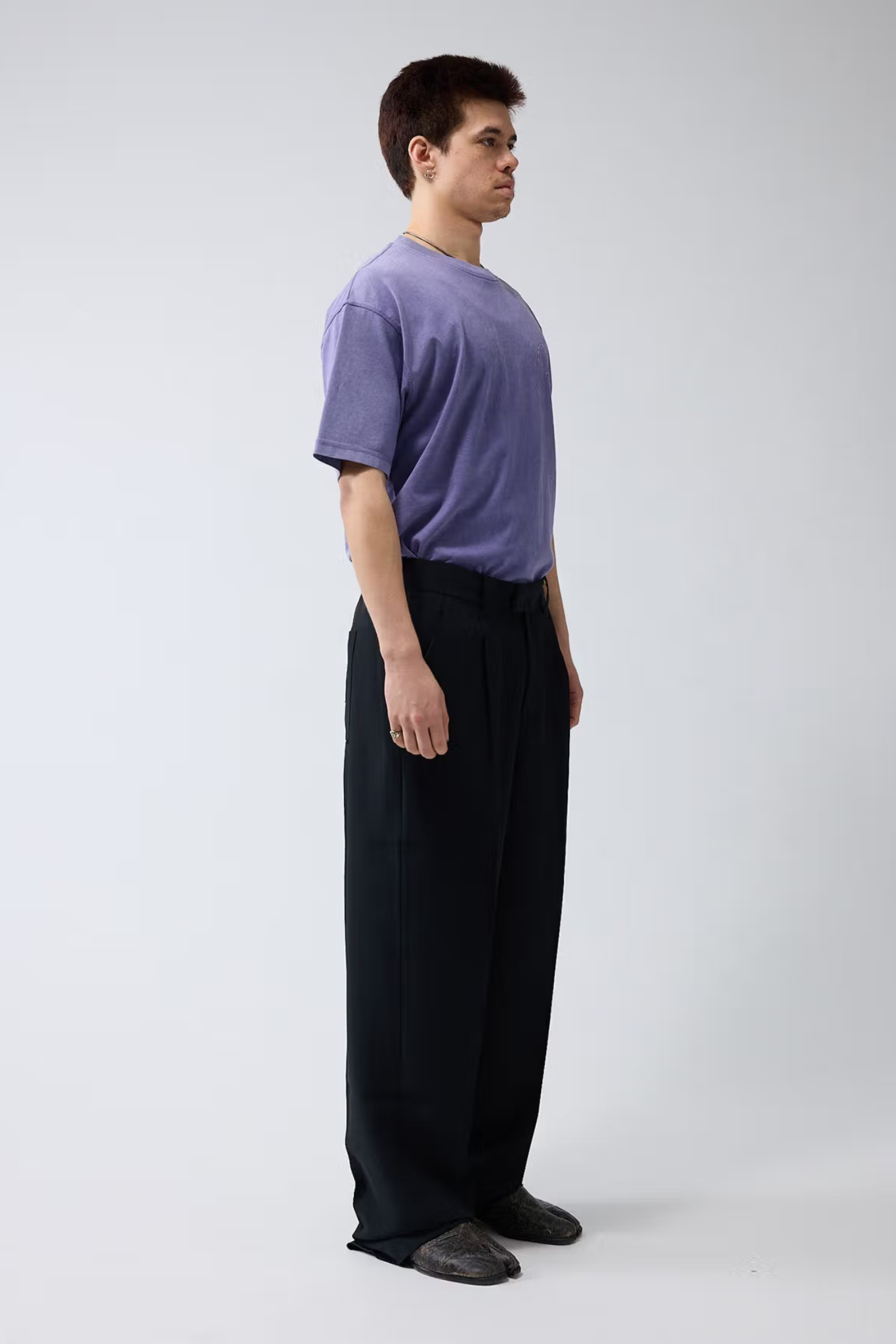 Model wearing the black New Amsterdam wool trousers. Side view