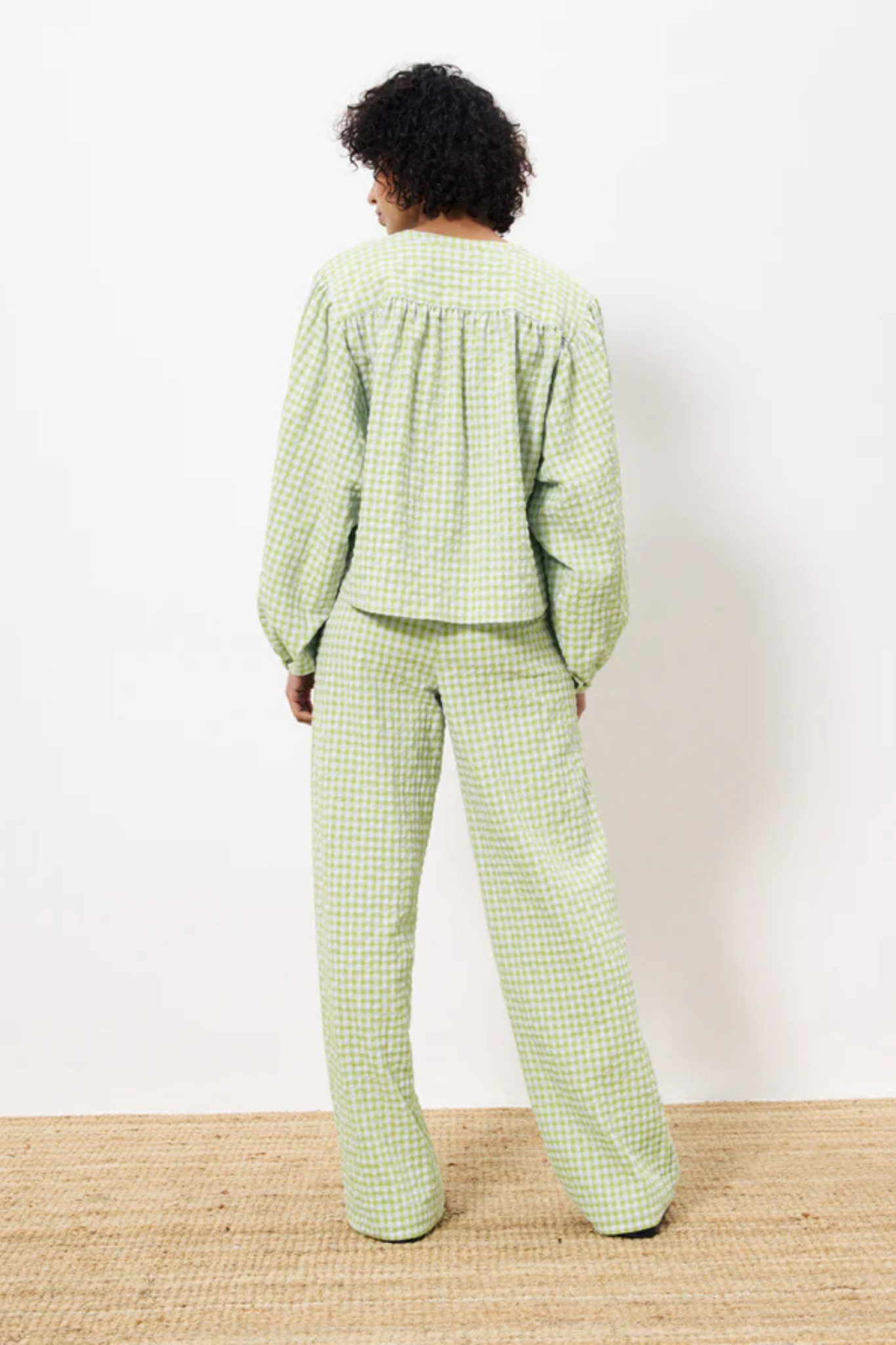 Model wearing the FRNCH noura blouse in green checked. Back view