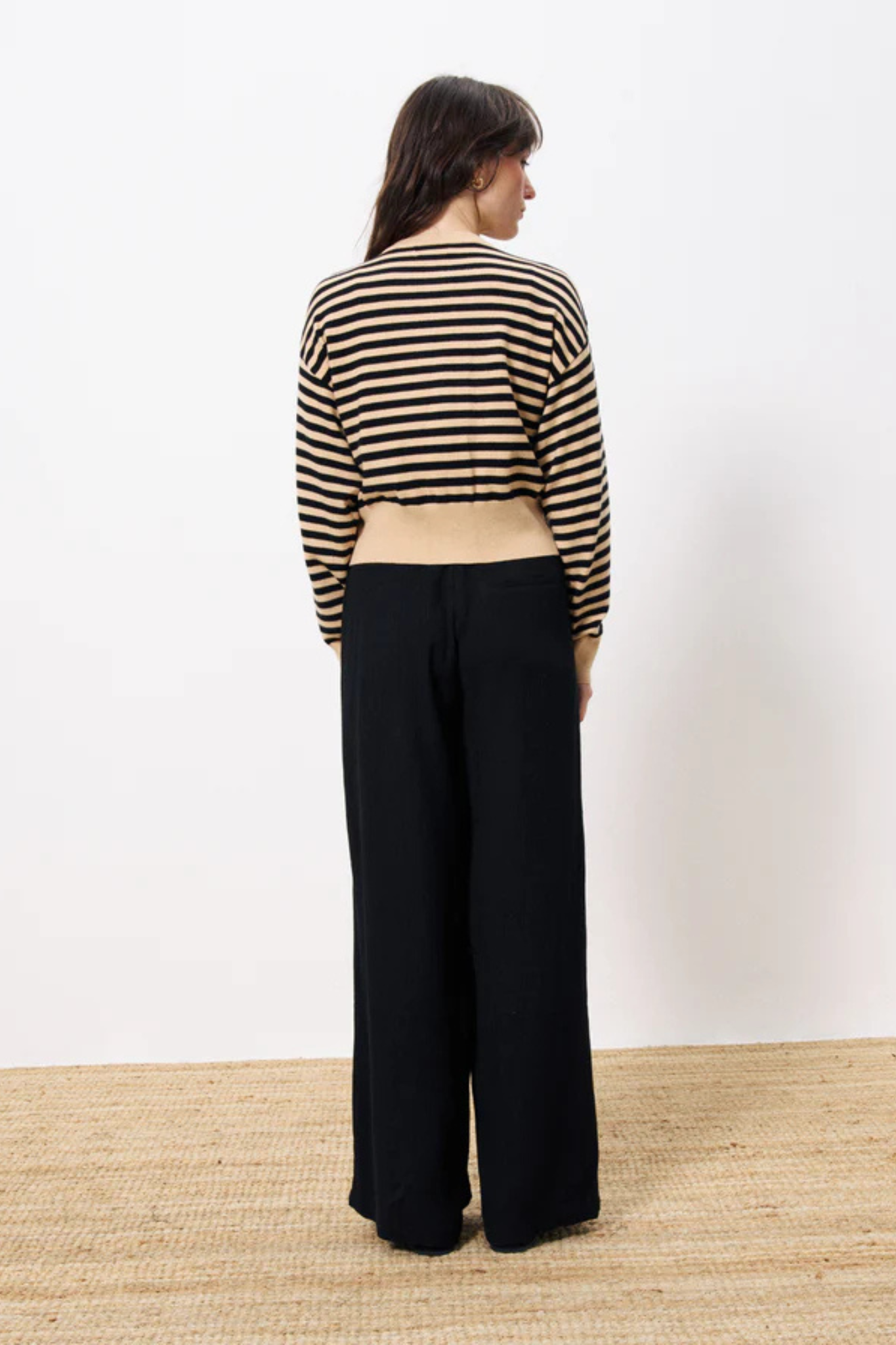 Model wearing the FRNCH noumea cardigan striped in black and beige. Front view