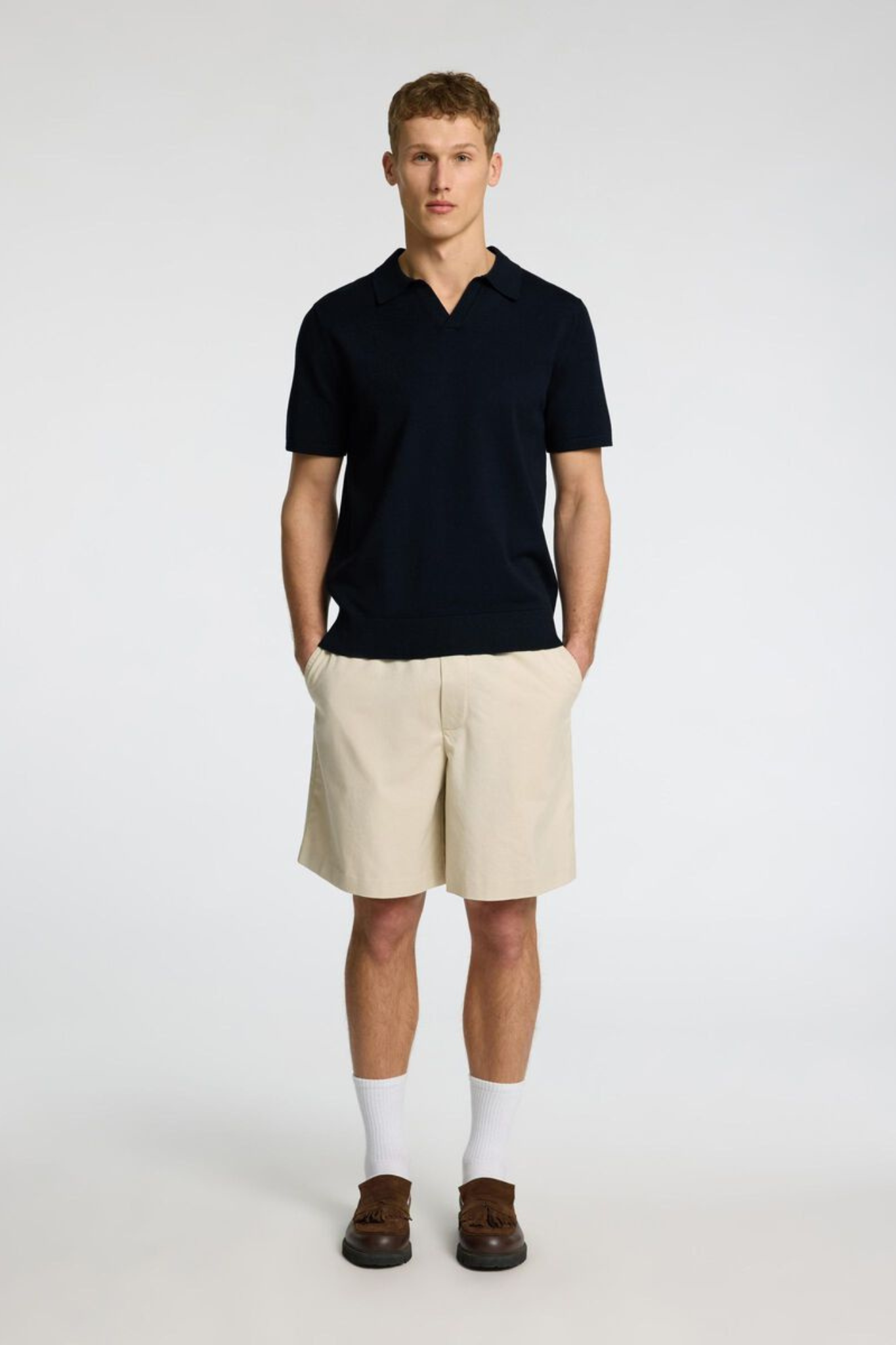 Model wearing the Selected Homme teller knit polo in sky captain. Front view