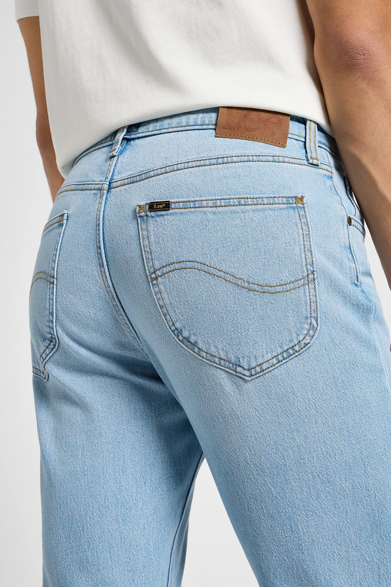 Model wearing the Lee west jeans in light blue. Back pocket view