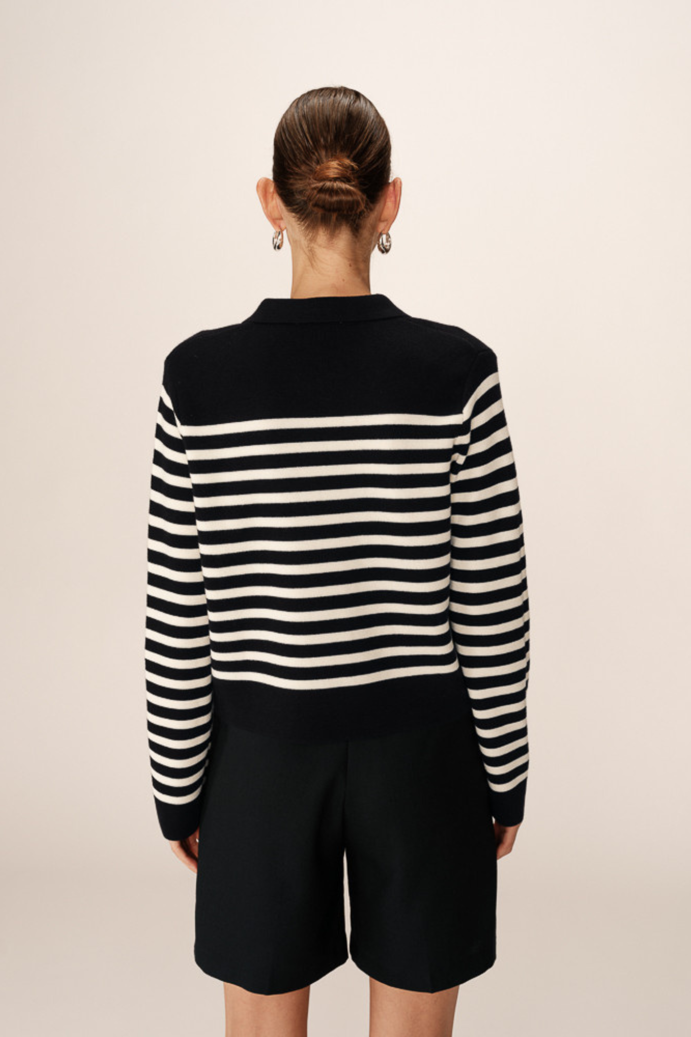 Model wearing the Grace & Mila pam cardigan in marine stripes in black and white. Back view