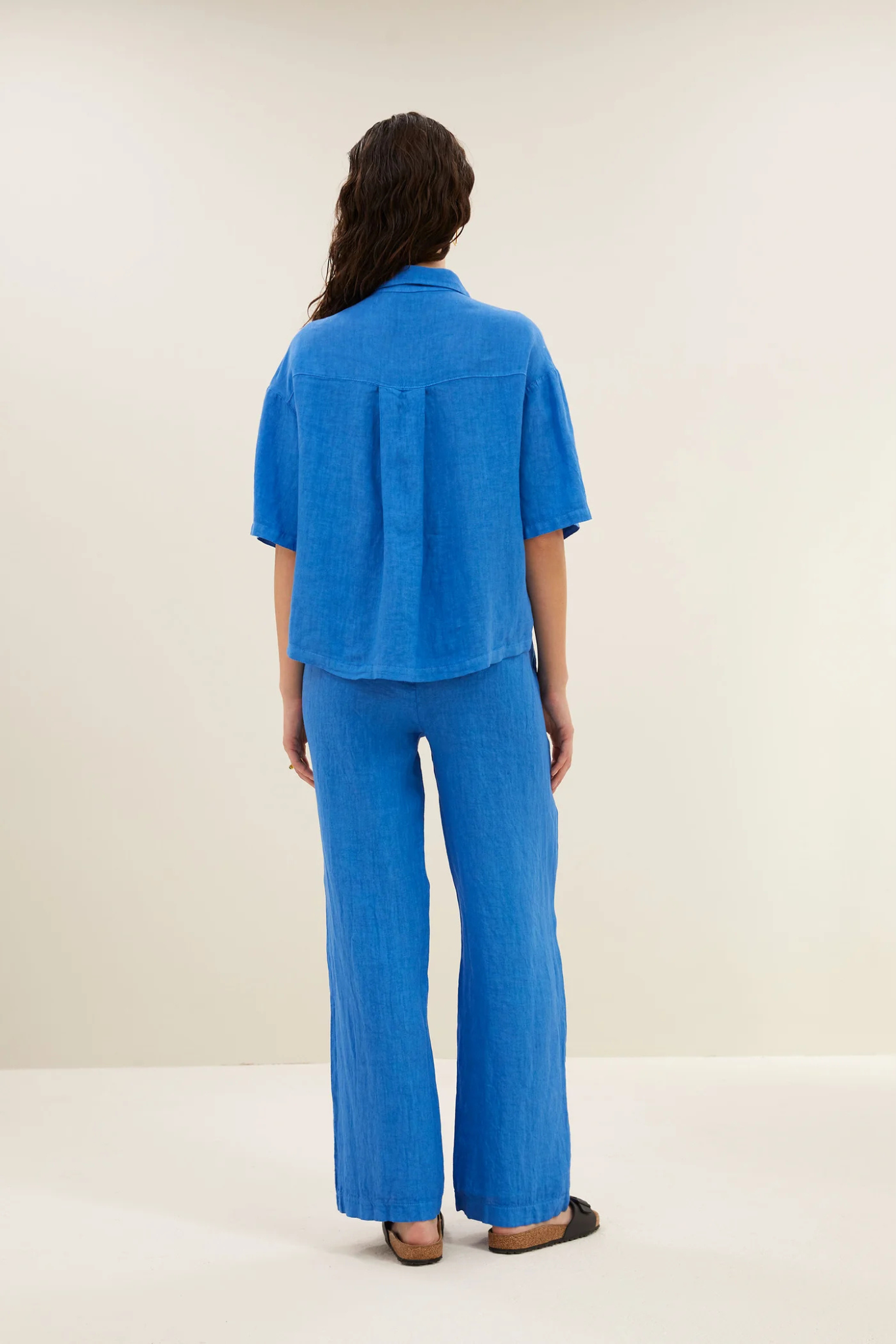 Model wearing the By-Bar cris linen blouse in queens blue. Back view