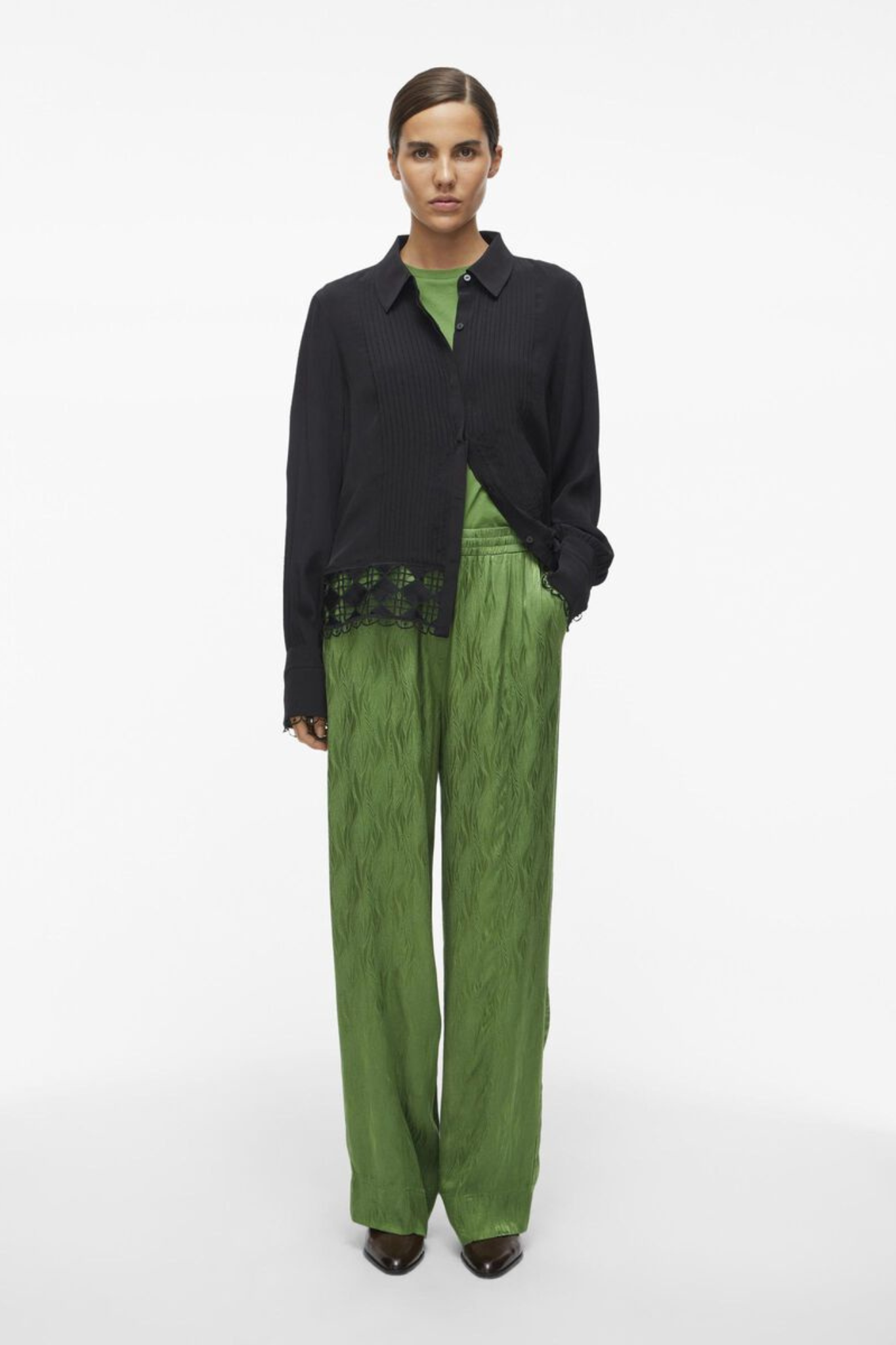 Model wearing the Rouge Edit artichoke green Roumarta trousers. Front view